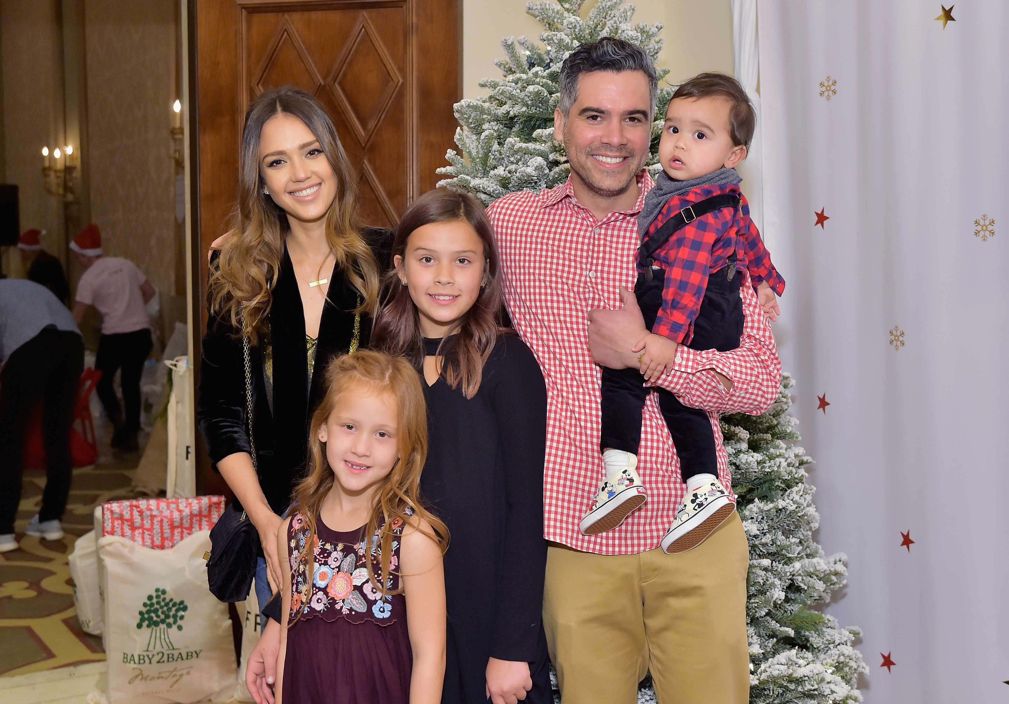 Jessica Alba and Cash Warren, with their children Haven, Honor, and Hayes, attend the Baby2Baby Holiday Party on December 16, 2018 | Source: Getty Images