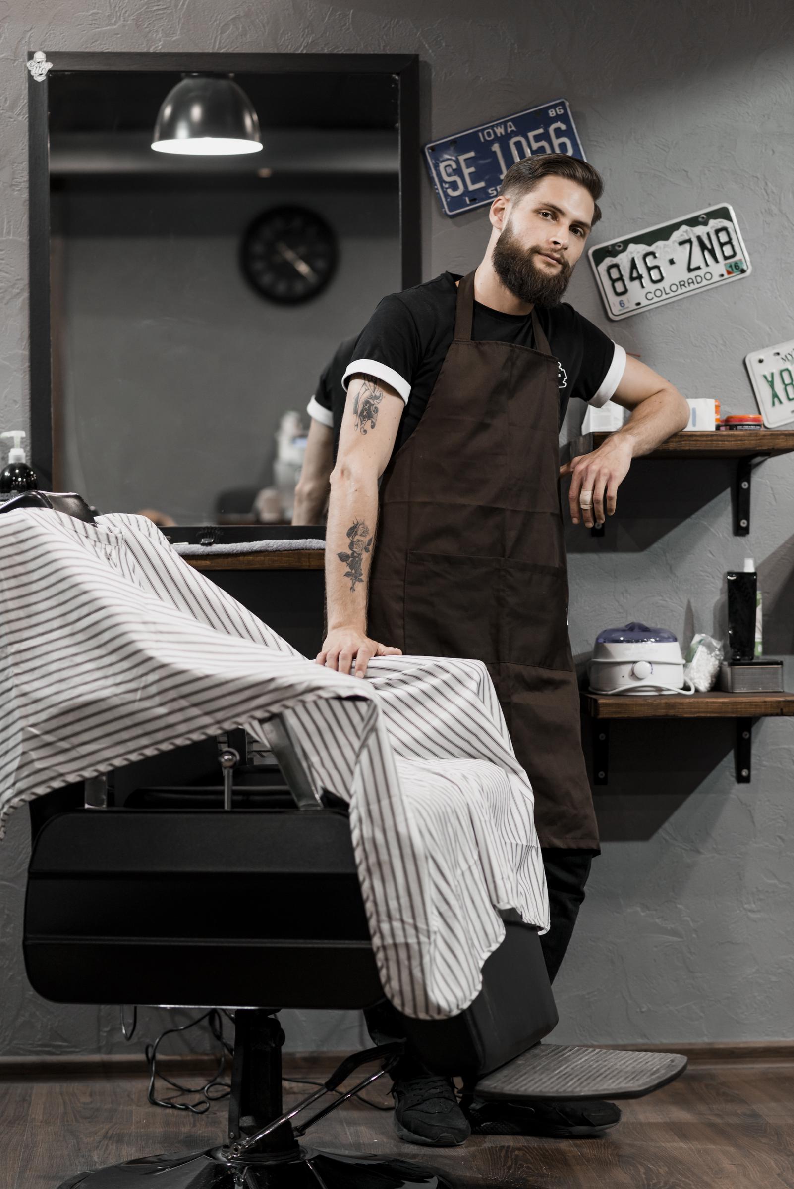 A hairdresser standing in a barber shop | Source: Freepik