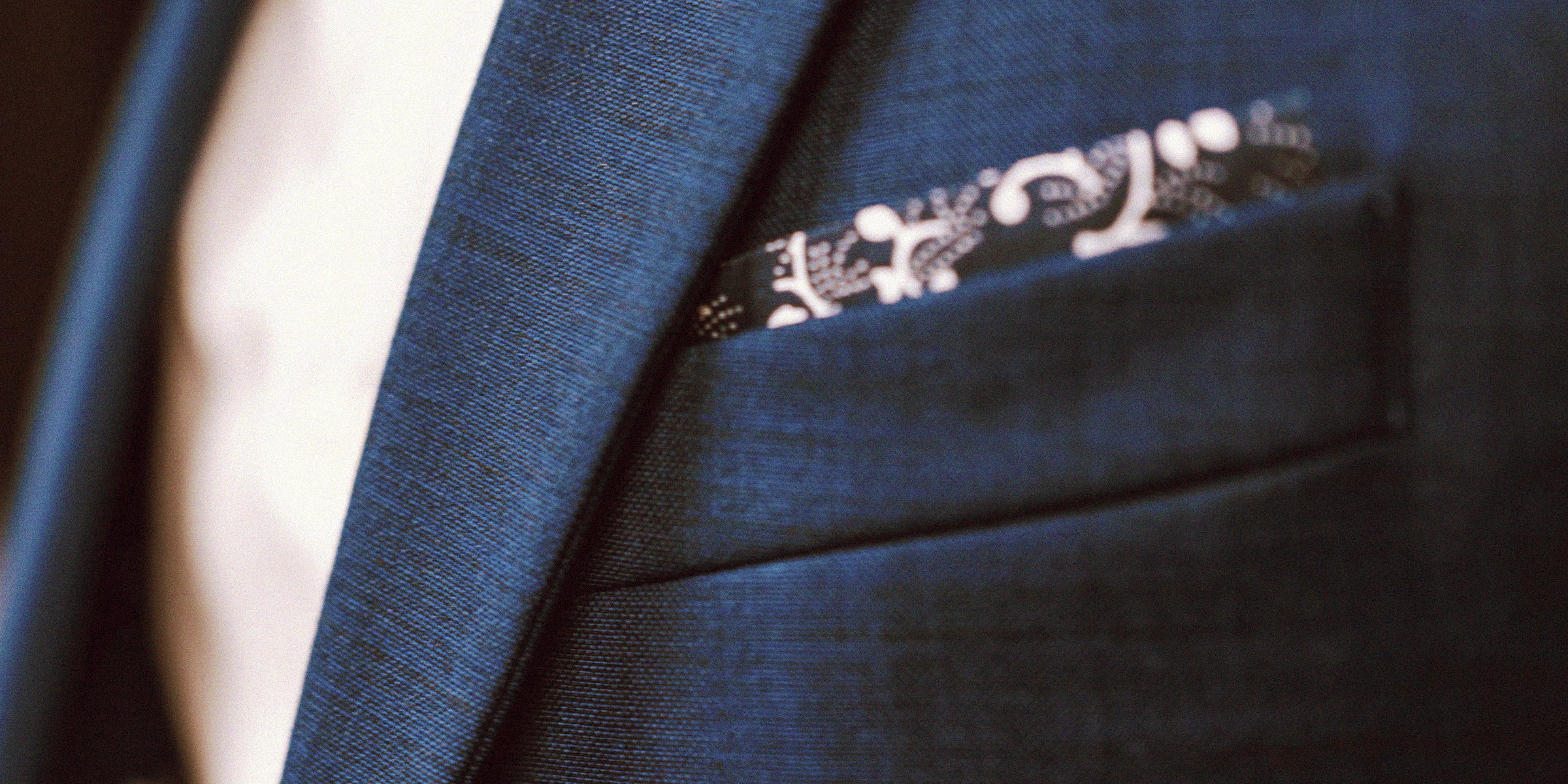 Unsplash | A close up of a suit with a pocket square