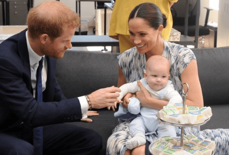 Prince Harry and his wife Meghan Markle hold their baby son Archie as they met with Archbishop Desmond Tutu (unseen) at the Tutu Legacy Foundation, on September 25, 2019, Cape Town South Africa | Source; HENK KRUGER/POOL/AFP via Getty Images