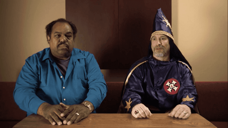Daryl Davis talking with a person wearing a Ku Klux Klan cloak in the trailer of the documentary film "Accidental Courtesy" | Source: YouTube/Accidental Courtesy