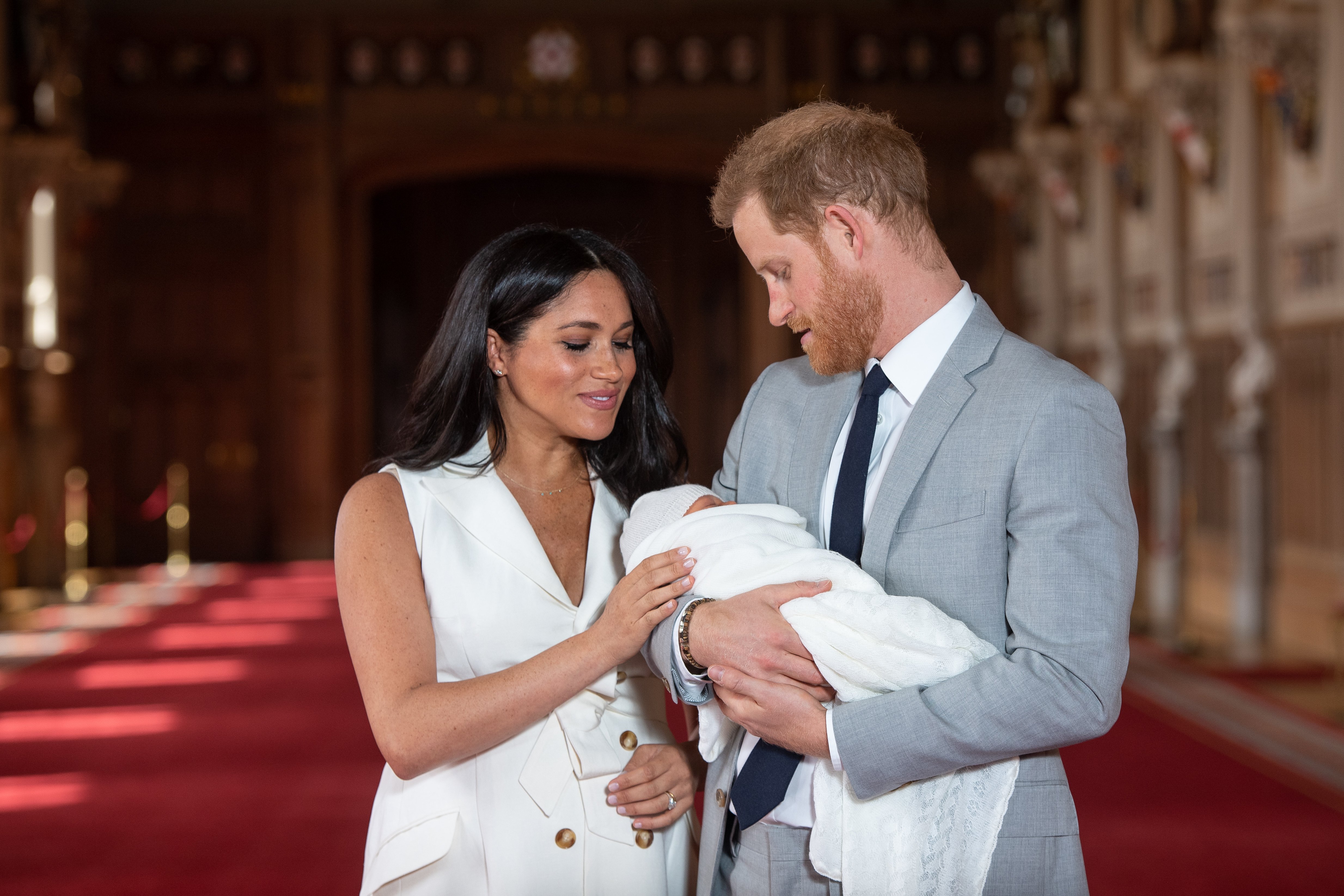 Prince Harry, Duke of Sussex and Meghan, Duchess of Sussex, pose with their newborn son Archie Harrison Mountbatten-Windsor during a photocall in St George's Hall at Windsor Castle on May 8, 2019 in Windsor, England. | Source: Getty Images