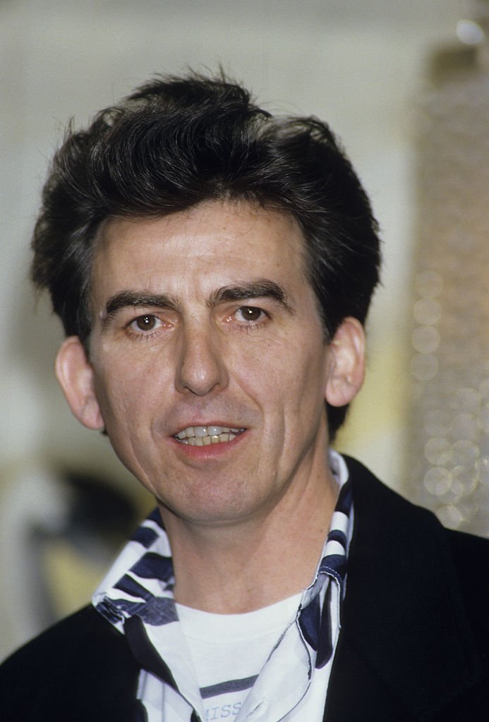 Former Beatle George Harrison holds a press Conference with Madonna for their film 'Shanghai Surprise' at the Kensington Roof Gardens | Getty Images / Global Images Ukraine Former Beatle George Harrison holds a press Conference with Madonna for their film 'Shanghai Surprise' at the Kensington Roof Gardens | Getty Images / Global Images Ukraine