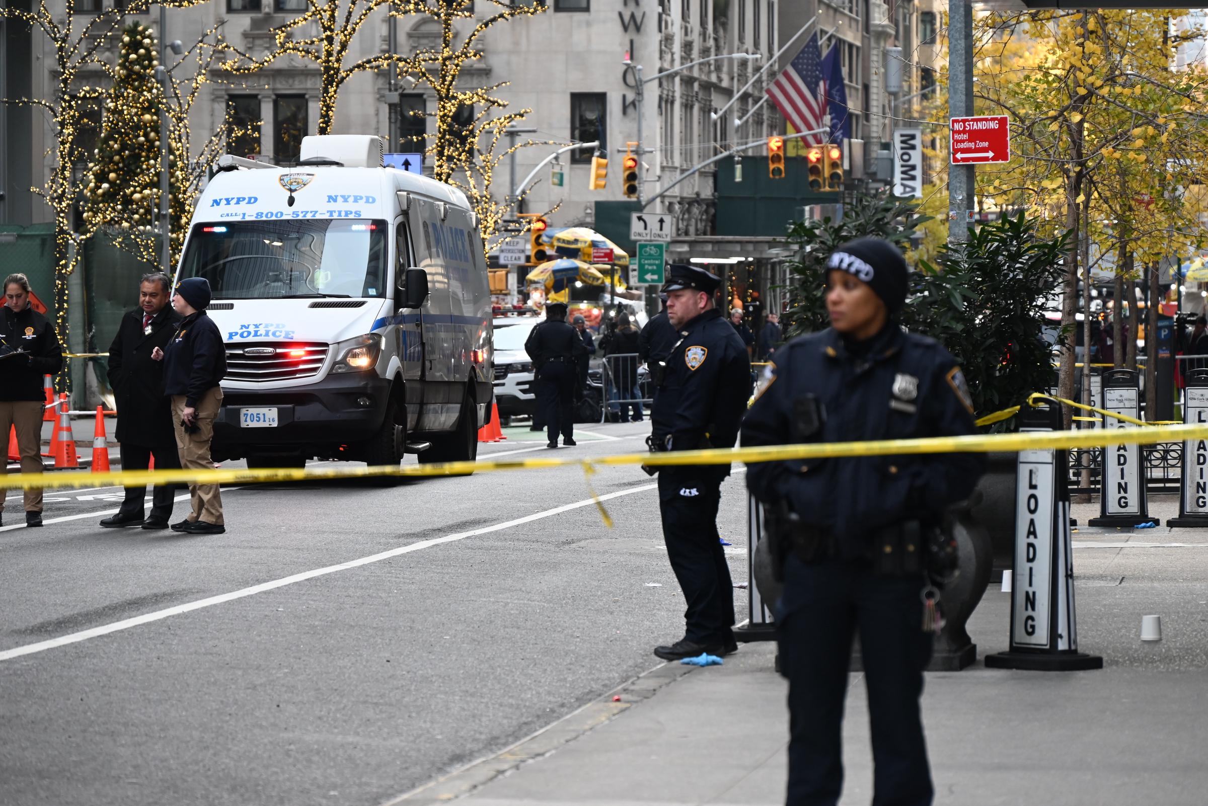 Police officers take security measures at the scene of the CEO of UnitedHealthcare Brian Thompson's shooting in Midtown Manhattan, New York, on December 4, 2024 | Source: Getty Images