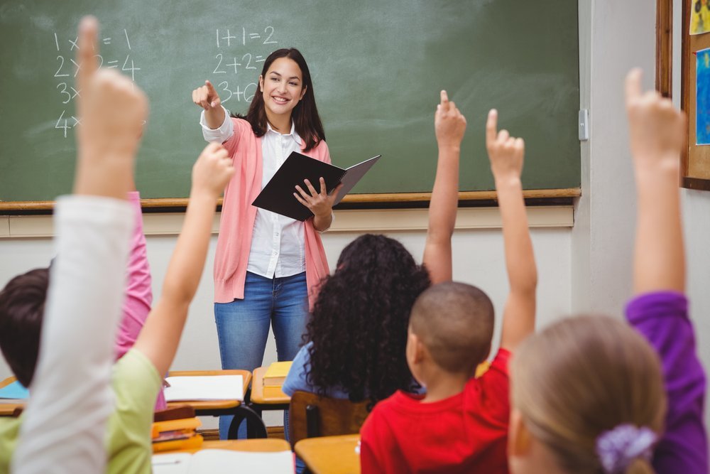 Teacher asking her students a question at the elementary school | Photo: Shutterstock