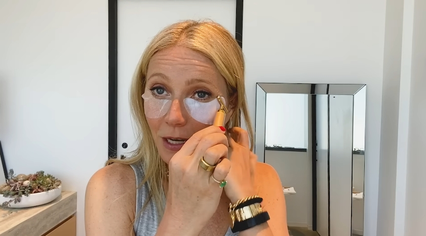 Gwyneth Paltrow applies hydrating eye patches and uses a sculpting tool as part of her skincare routine. | Source: YouTube/Vogue