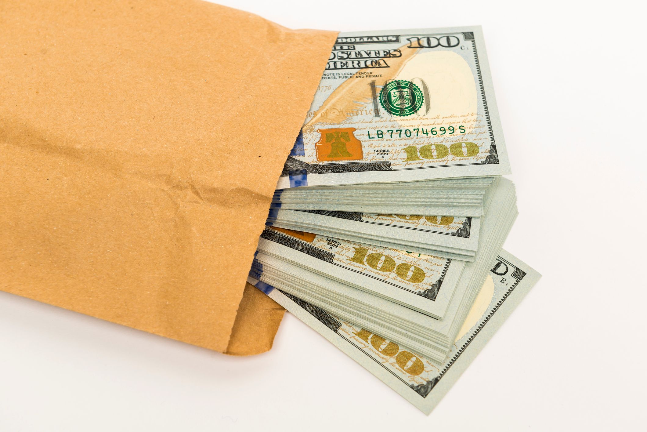 Dollar bills in an envelope | Source: Getty Images