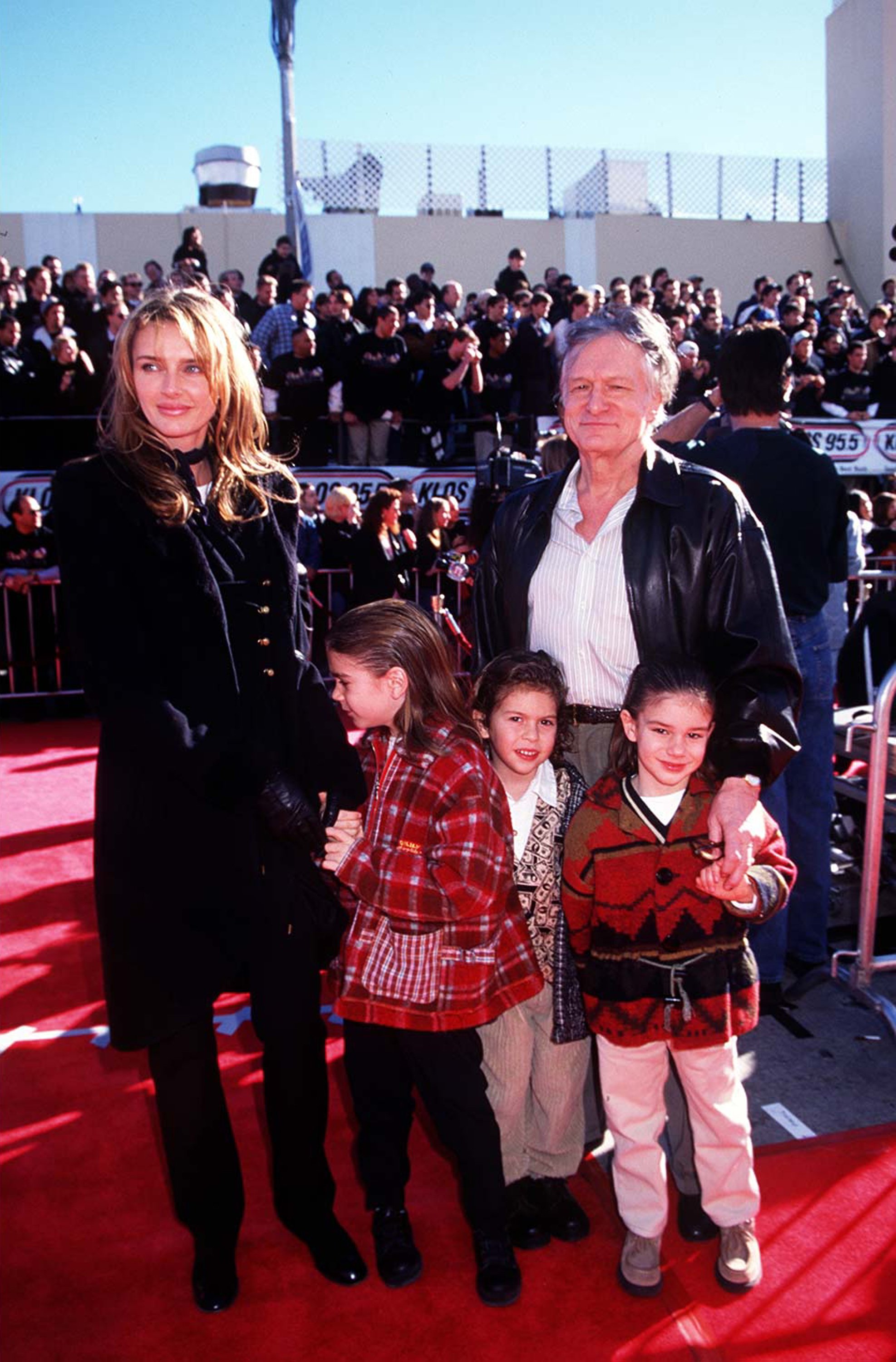 Hugh Hefner, Kimberly Hefner and their children posing at the Premiere of "Star Wars: Special Edition" In 1997 in Westwood | Source: Getty Images