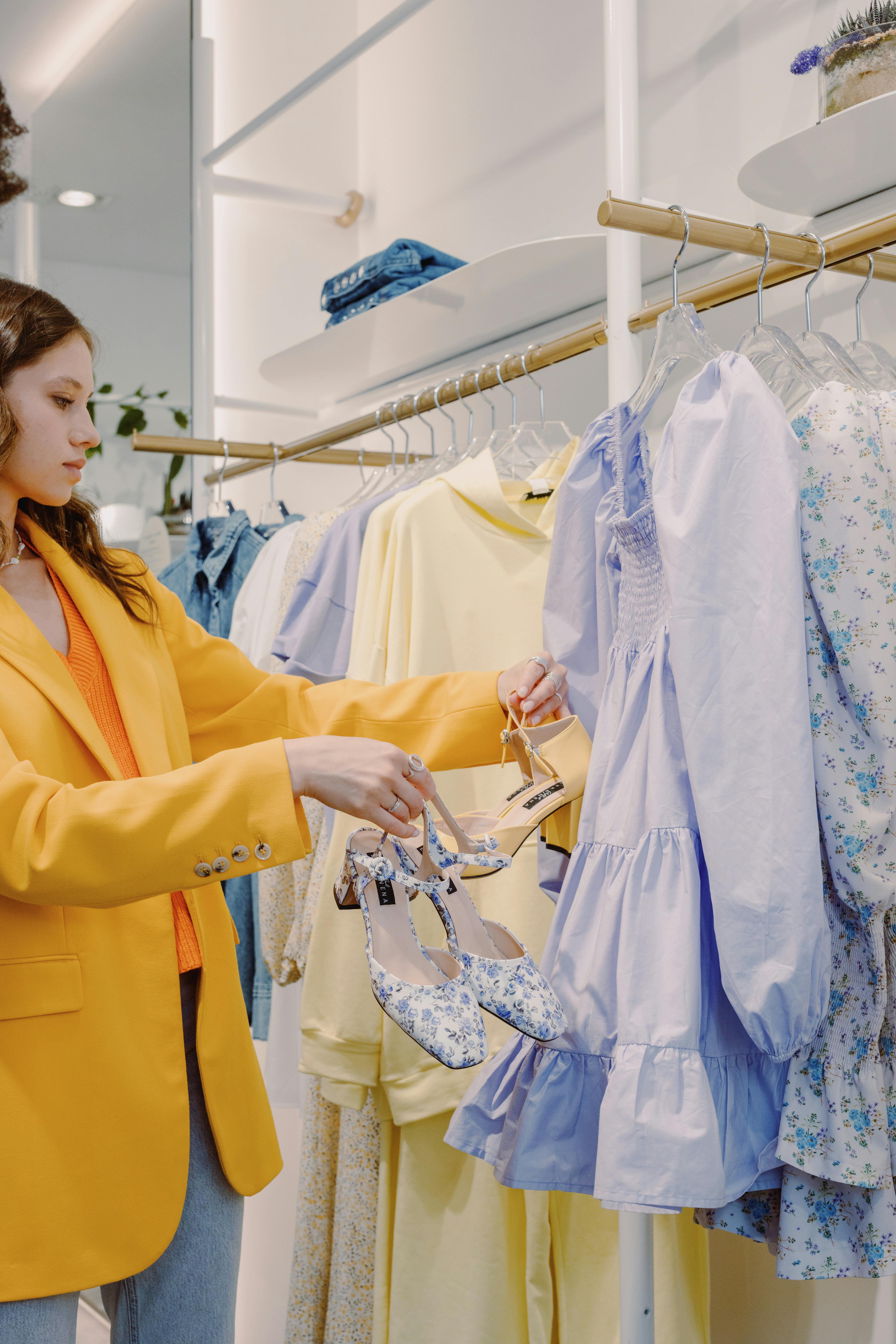 A woman shopping for dresses and shoes | Source: Pexels