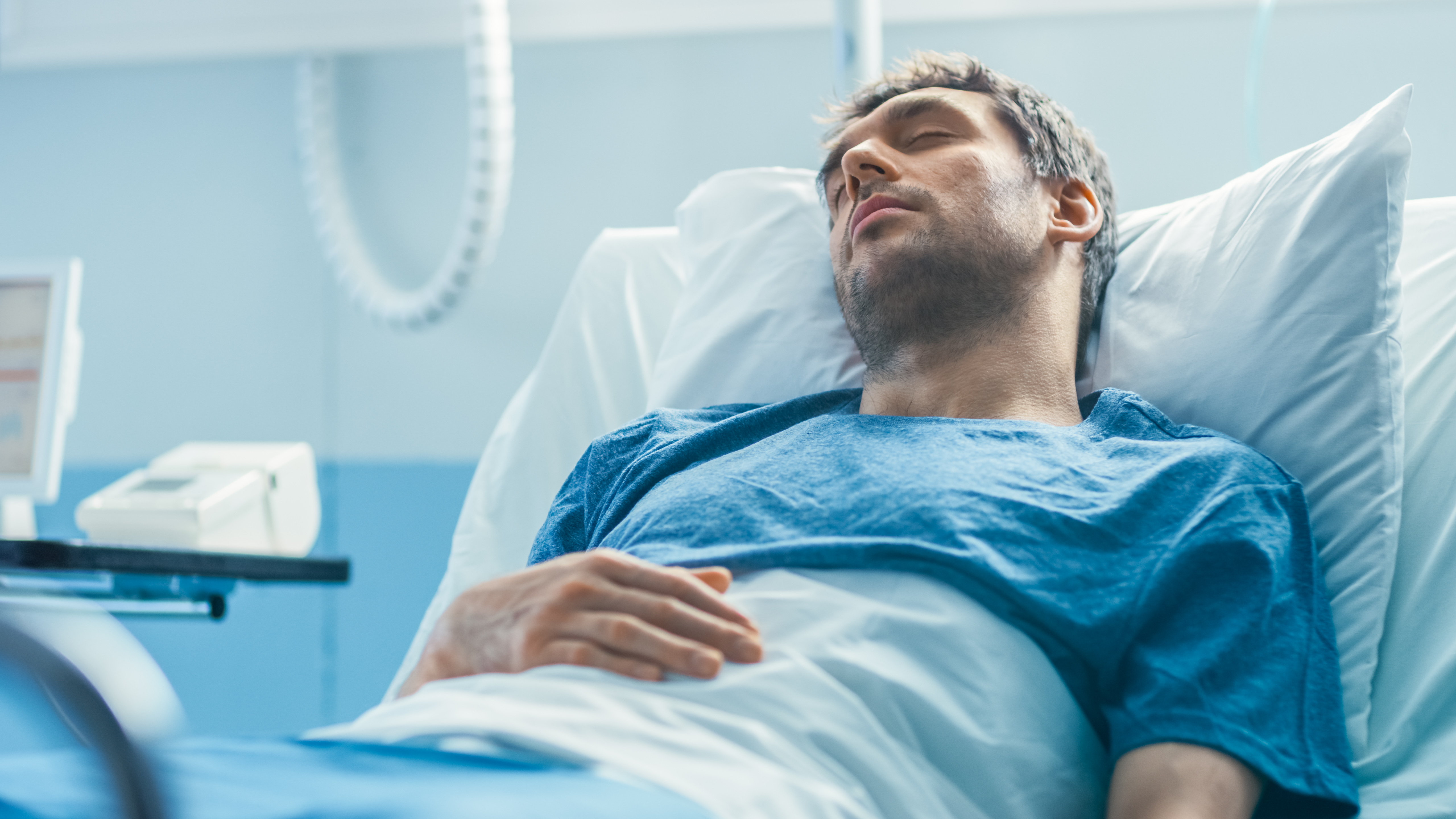 Man is sleeping in hospital bed | Source: Shutterstock.com