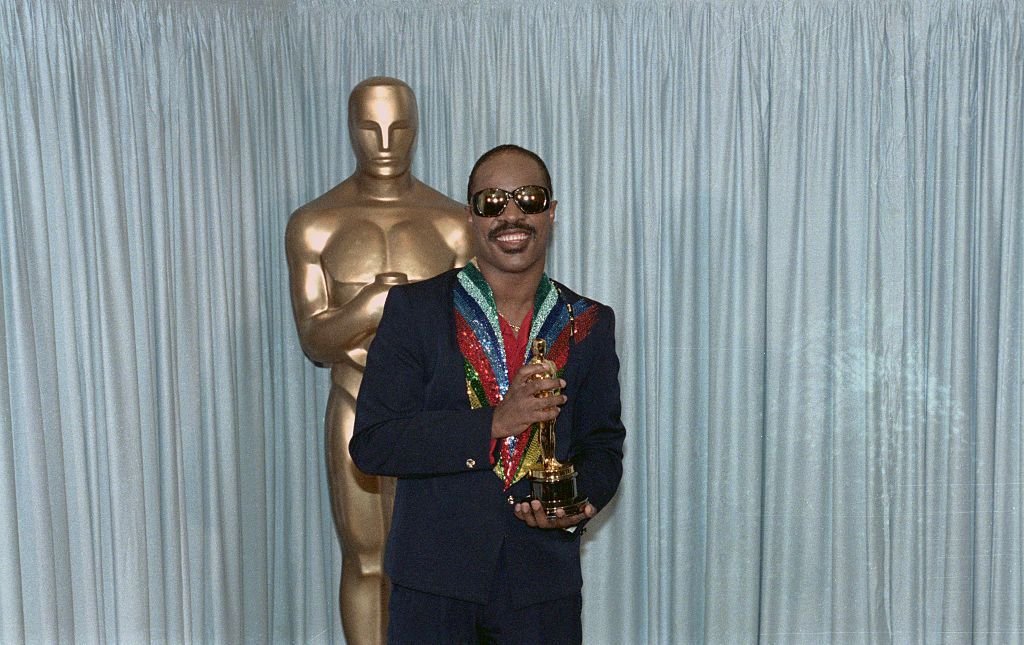 Stevie Wonder holds his Oscar award for the category of Best Song. | Source: Getty Images