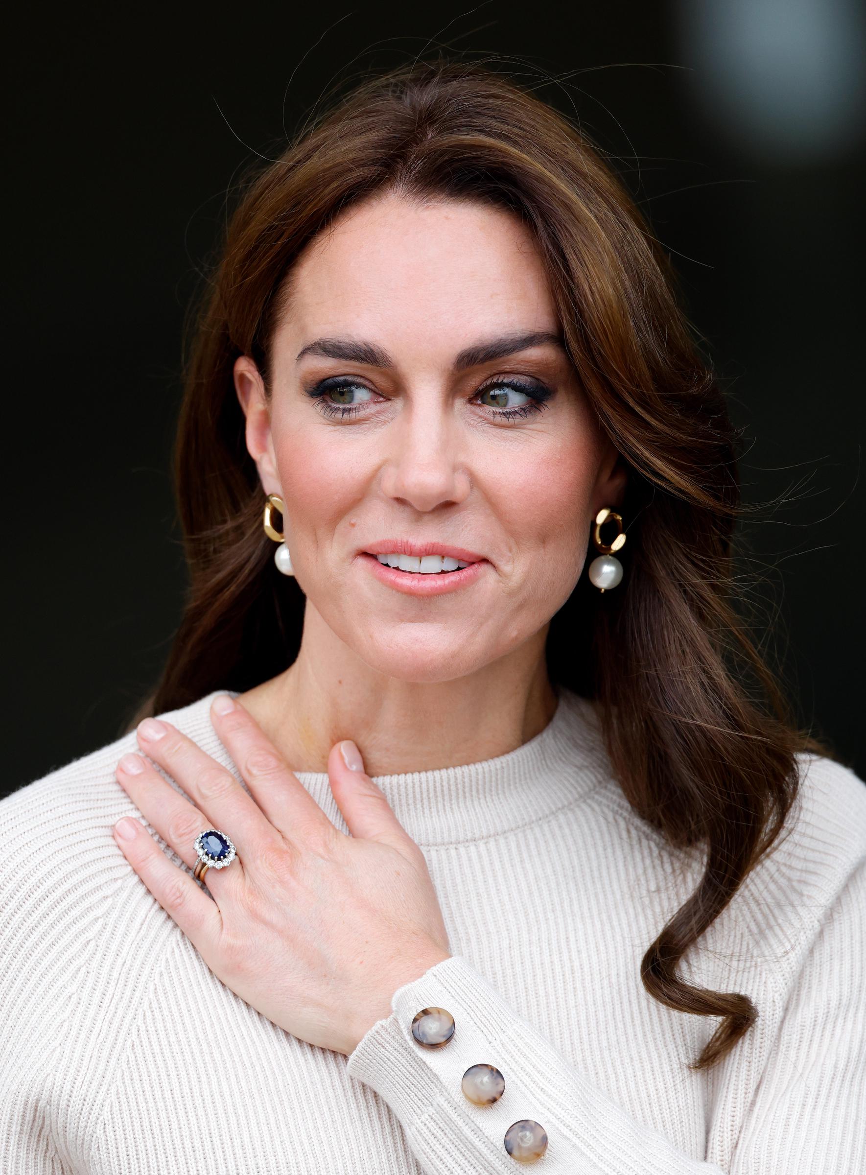 While visiting Nottingham Trent University on October 11, 2023, Princess Catherine beams in a blue outfit; her soft, chestnut brown waves cascading past her shoulders, adding polish to the casual daytime ensemble.
