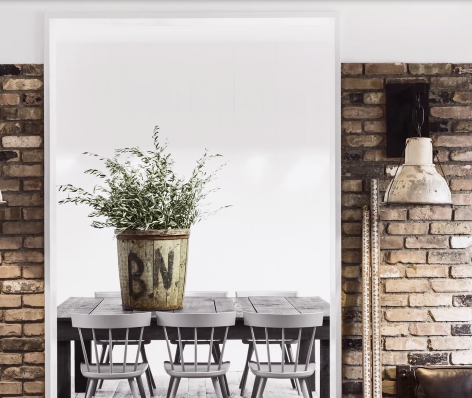 Wooden dining table with spindle-back chairs and a rustic planter inside Diane Keaton’s Sullivan Canyon home, dated February 3, 2022 | Source: YouTube/@FamousEntertainment500k