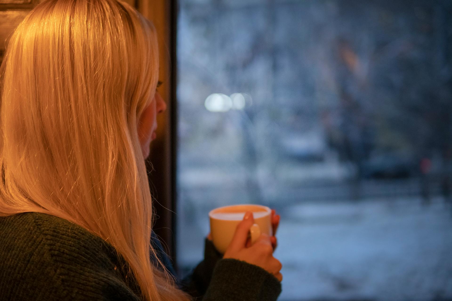 A woman looking out the window | Source: Pexels