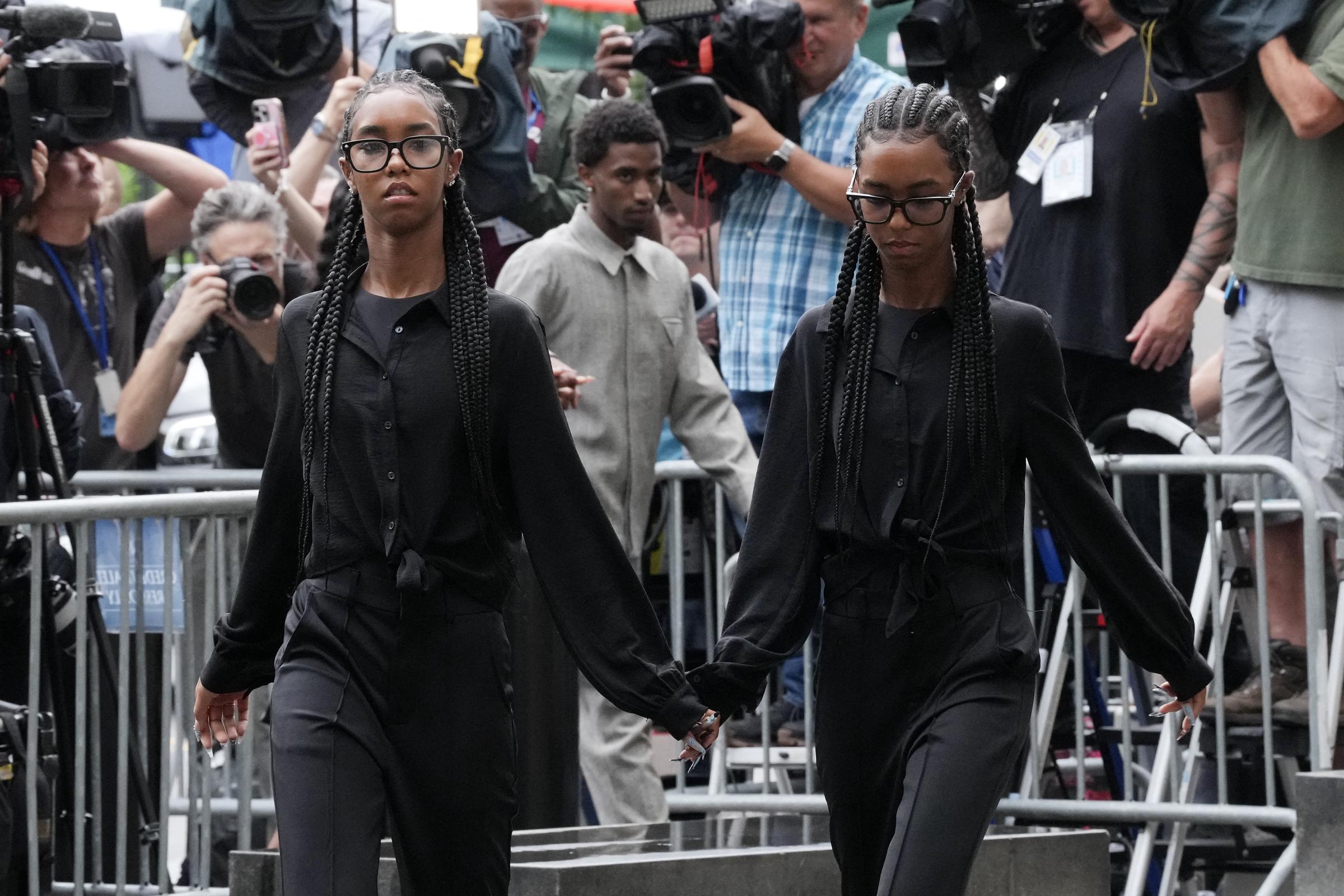 On July 2, 2025, at Manhattan Federal Court, Jessie and Lila Combs walk hand in hand through a crowd of photographers. Both wear serious expressions, staying focused as they make their way inside.