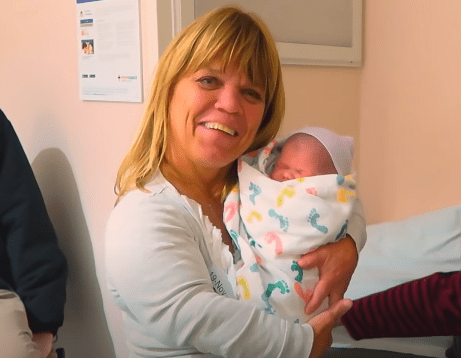 Amy Roloff holding her granddaughter Lilah for the first time. | Source: YouTube/TLC.