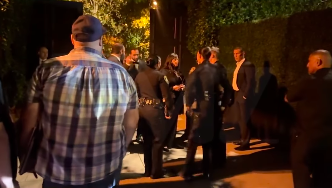 Police officers speaking with security as bystanders and guests look on, posted on November 9, 2025. | Source: Instagram/tmz_tv