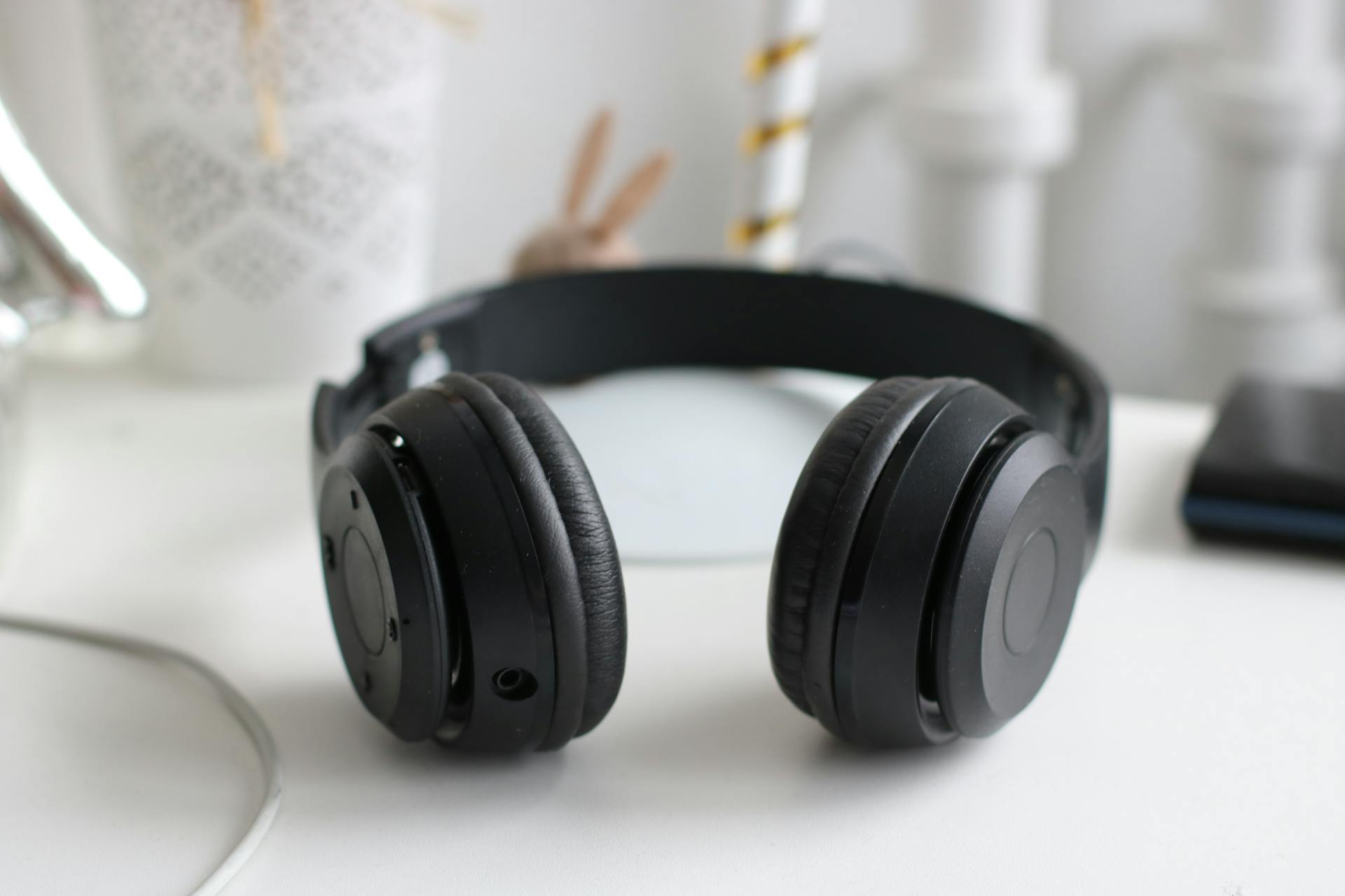 Headphones on a white surface | Source: Pexels