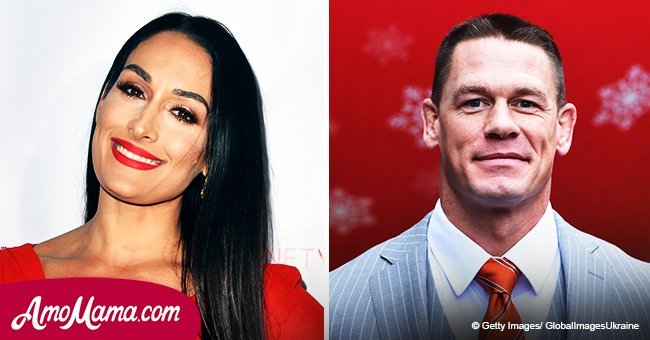 Nikki Bella flashes her curvy figure in a striking red dress as she goes on a date with John Cena