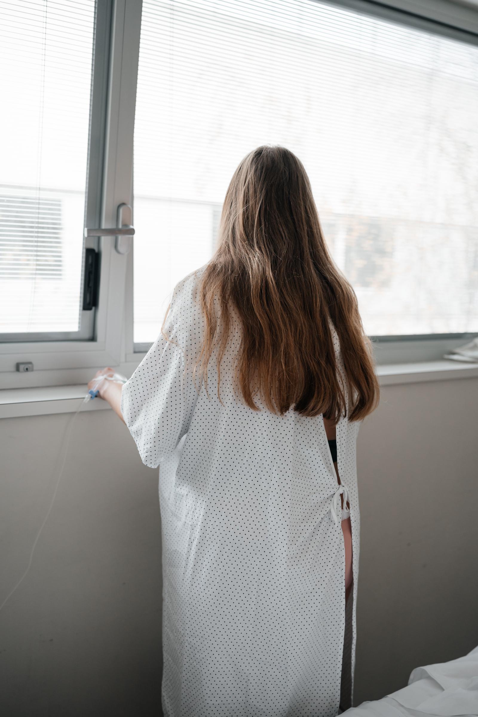 Woman in a hospital gown | Source: Shutterstock