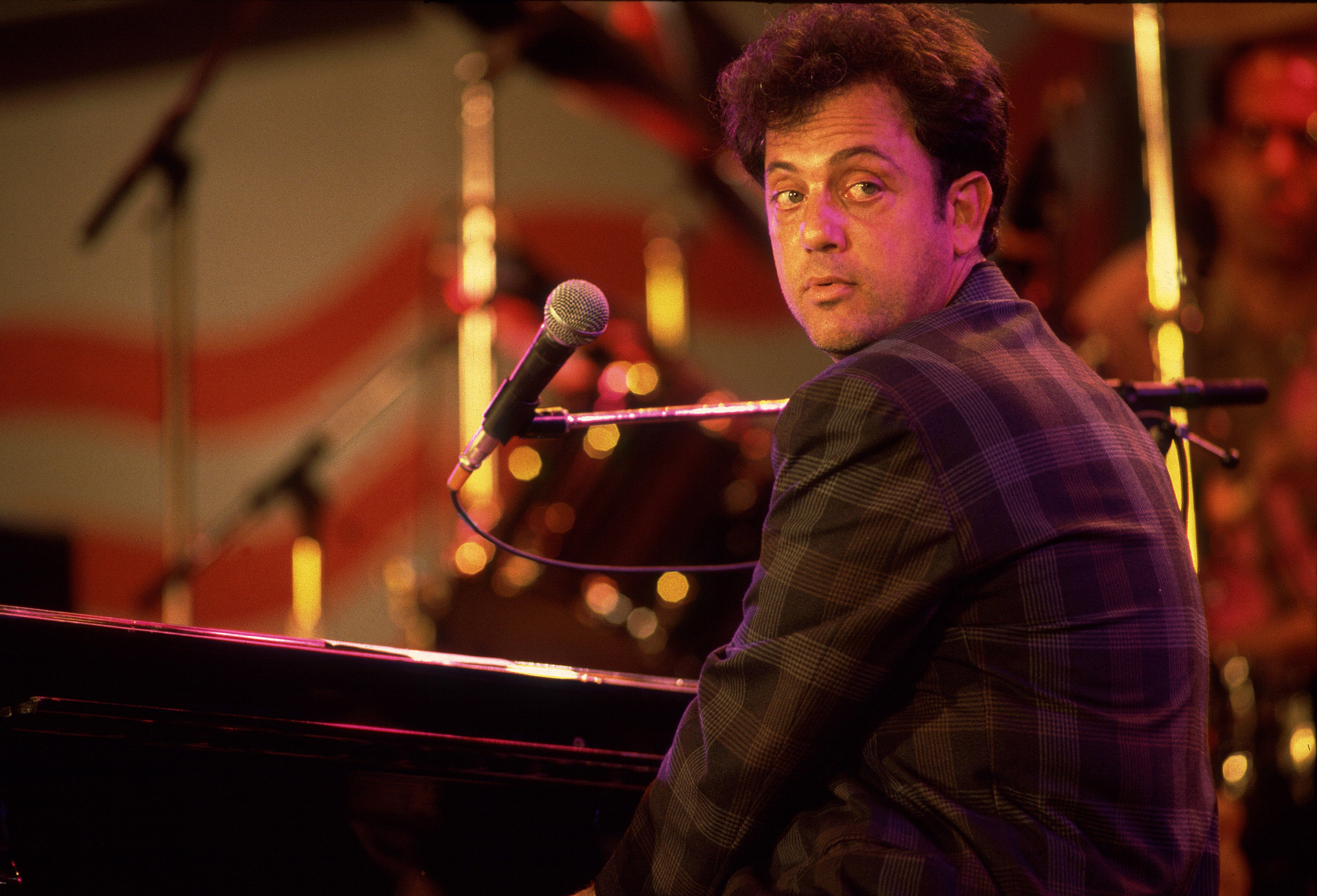 Pianist Billy Joel performing onstage during the first Farm Aid benefit concert at Memorial Stadium, Champaign, on September 22, 1985 in Illinois. / Source: Getty Images