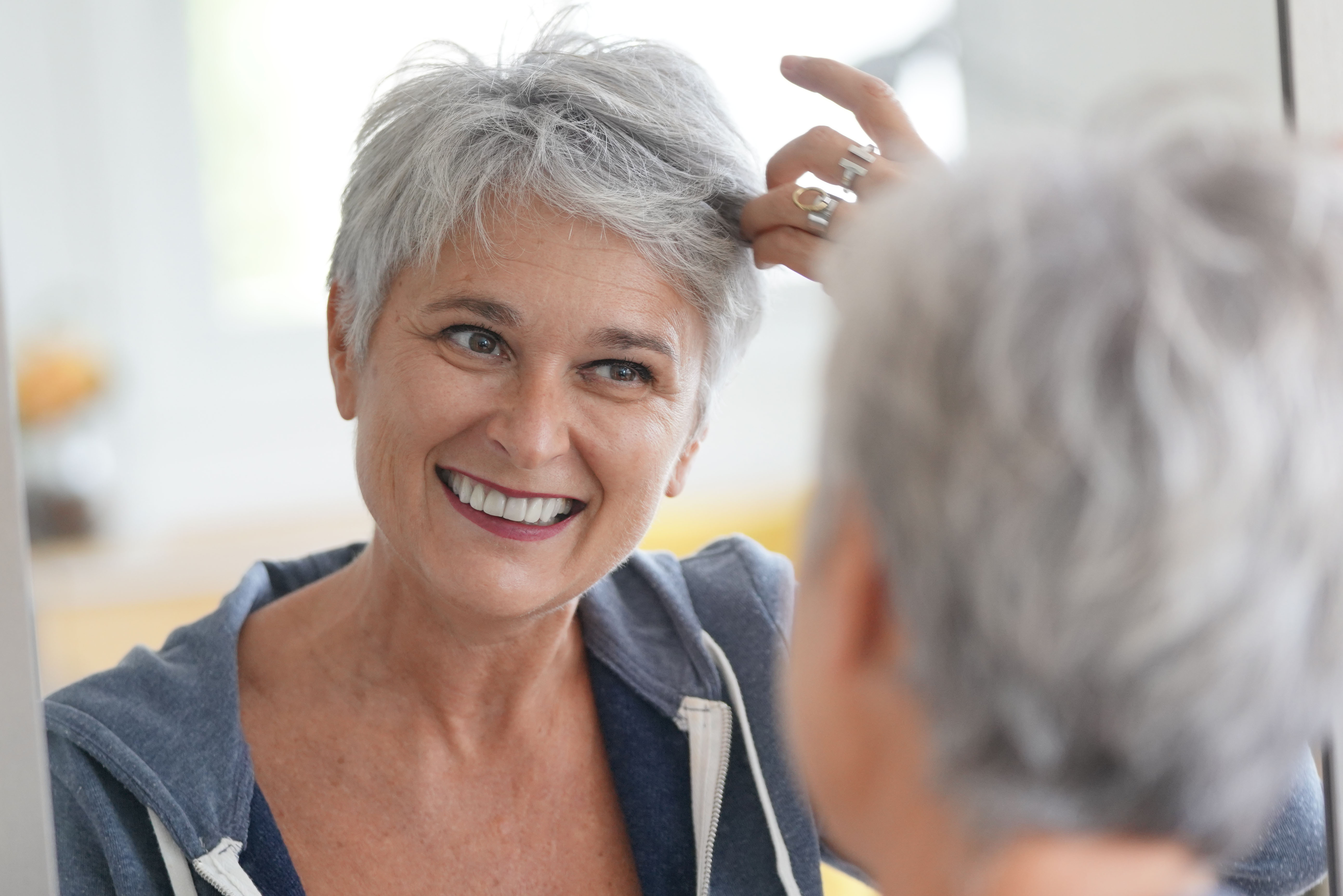A gray-haired woman wearing a blue jacket | Source: Shutterstock