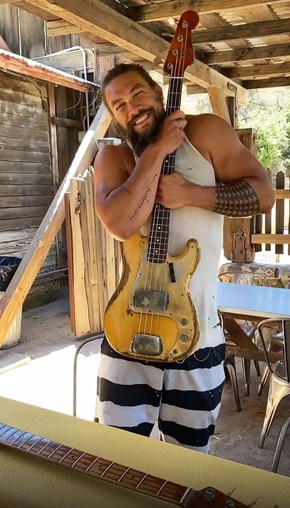 "Aquaman" and "Justice League" actor Jason Momoa holding the brand new bass guitar that he received on his 41st birthday | Photo: Instagram.com/prideofgypsies