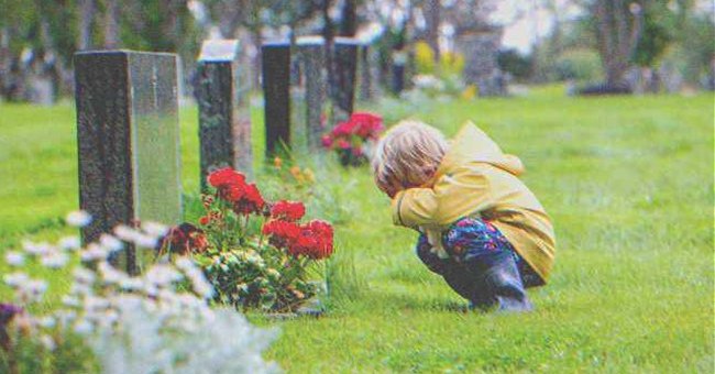 A kid kneeling in front of a grave | Source: Shutterstock
