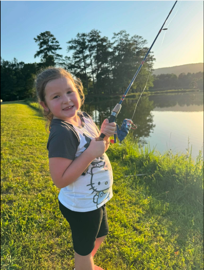 Emersyn "Emmy" Bridgers smiles while holding a fishing rod in a photo shared by her family. Jordan Thompson later remembered her 6-year-old sister as someone who was "always smiling and always pouring kindness into those around her." | Source: Facebook/Jordan Thompson