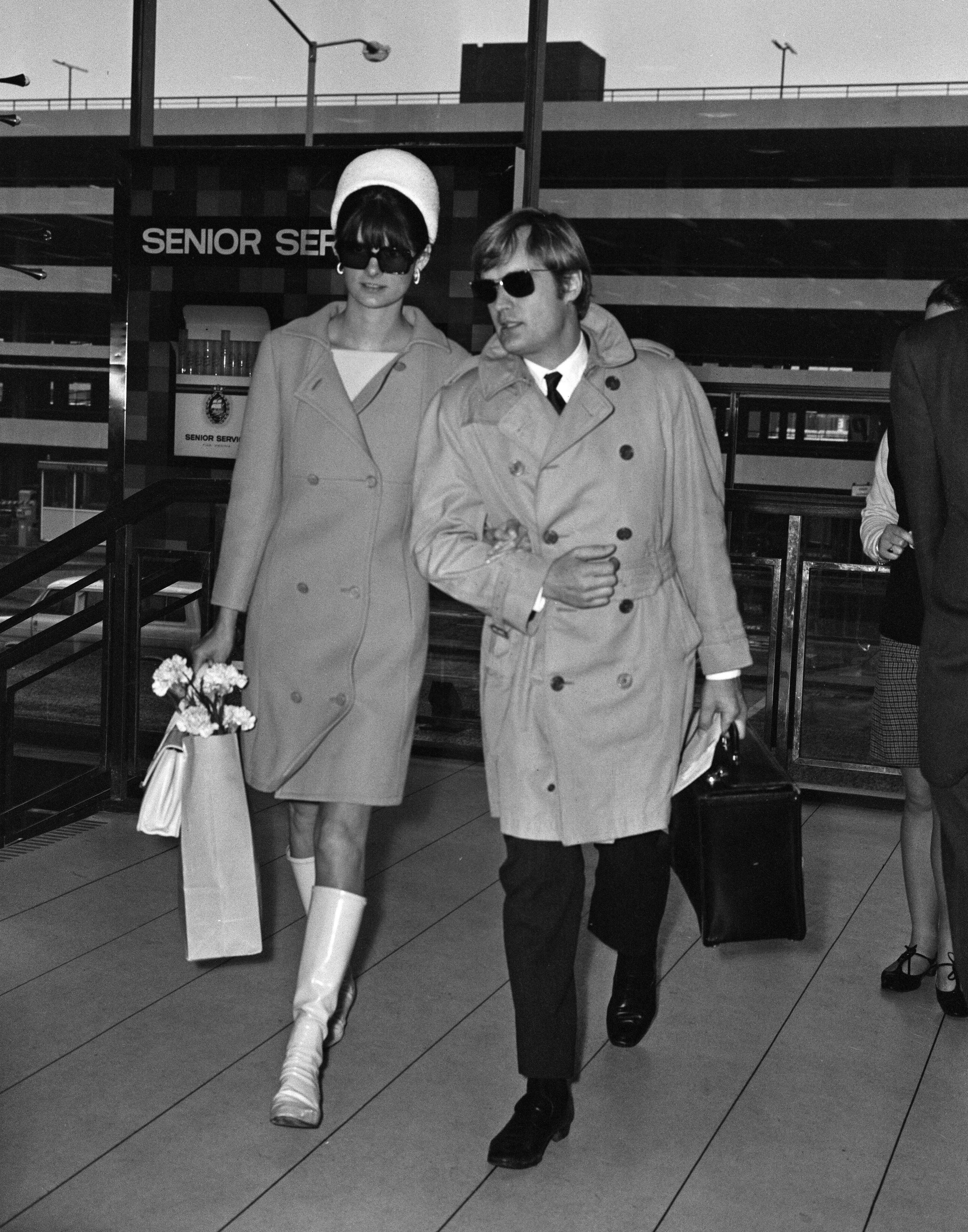 Actor David McCallum, one of the stars of the TV show 'The Man from U.N.C.L.E.' leaving Heathrow Airport for New York with his wife Katherine Carpenter, 18th January 1968 | Source: Getty Images