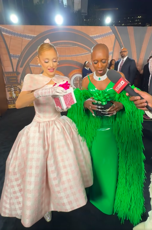 Ariana Grande and Cynthia Erivo opening up their presents from Access Hollywood, posted on November 10, 2024 | Source: Facebook/Access