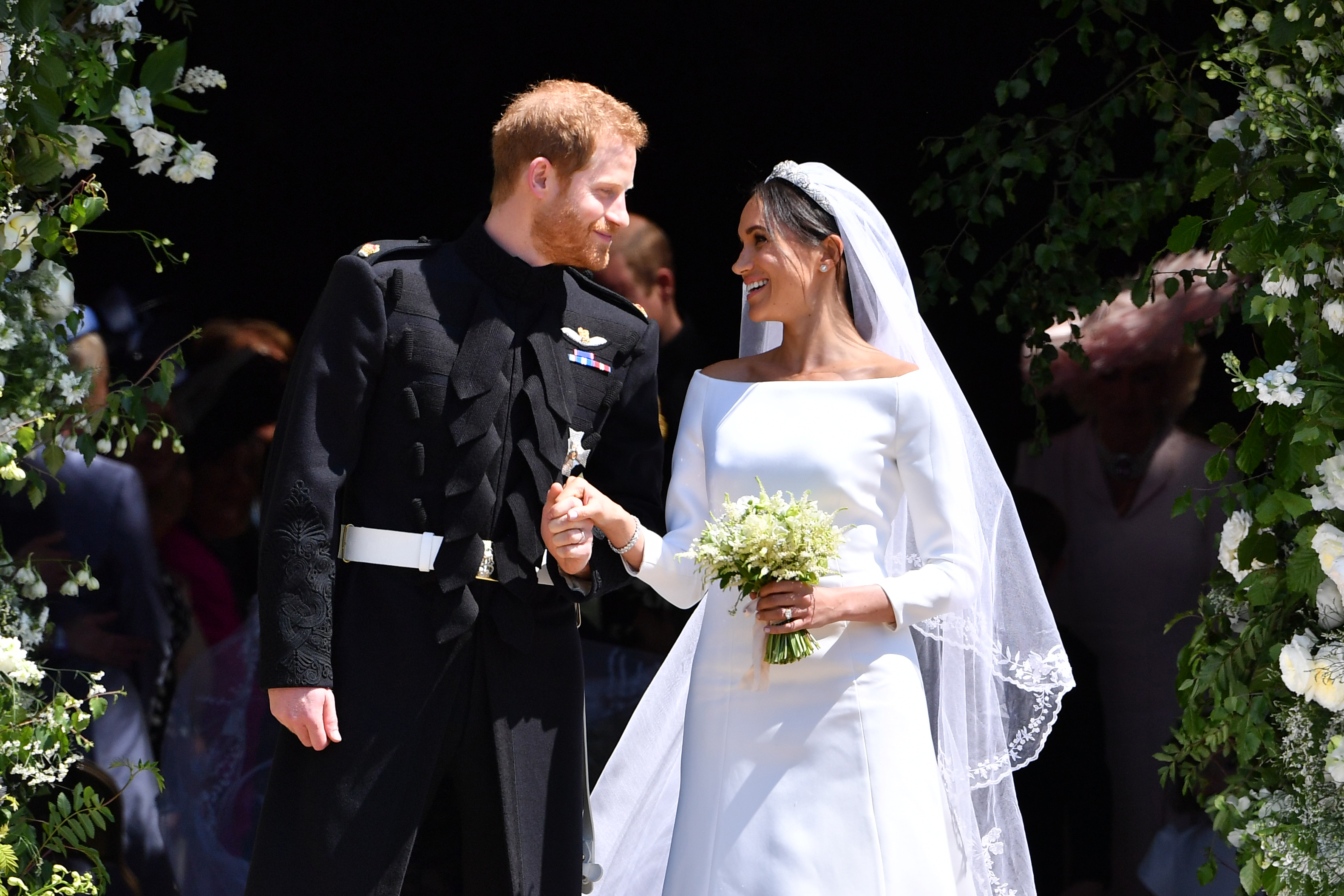 Prince Harry, Duke of Sussex and Meghan, Duchess of Sussex leave from the West Door of St George's Chapel on May 19, 2018 | Source: Getty Images