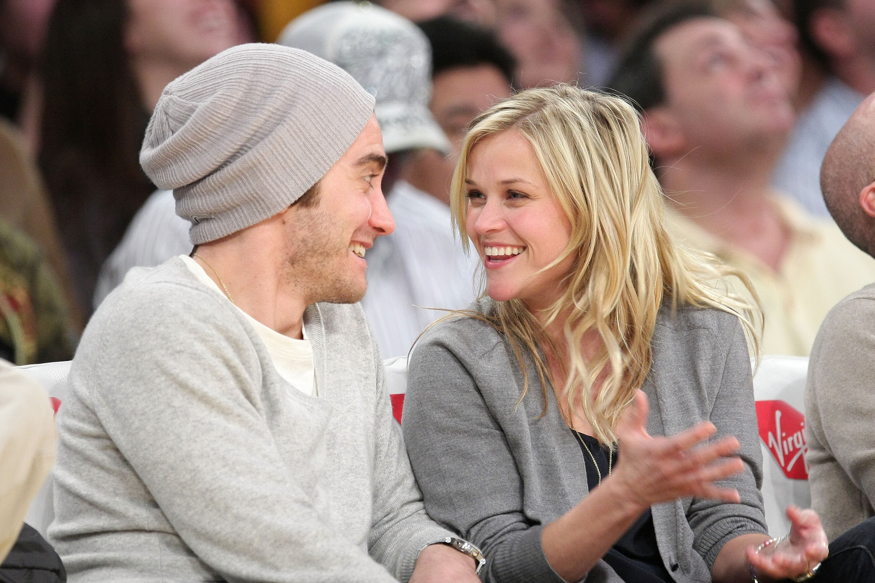 Gyllenhaal and Witherspoon smile broadly at each other after sharing a kiss, radiating happiness. The two look genuinely thrilled to be in each other's company.