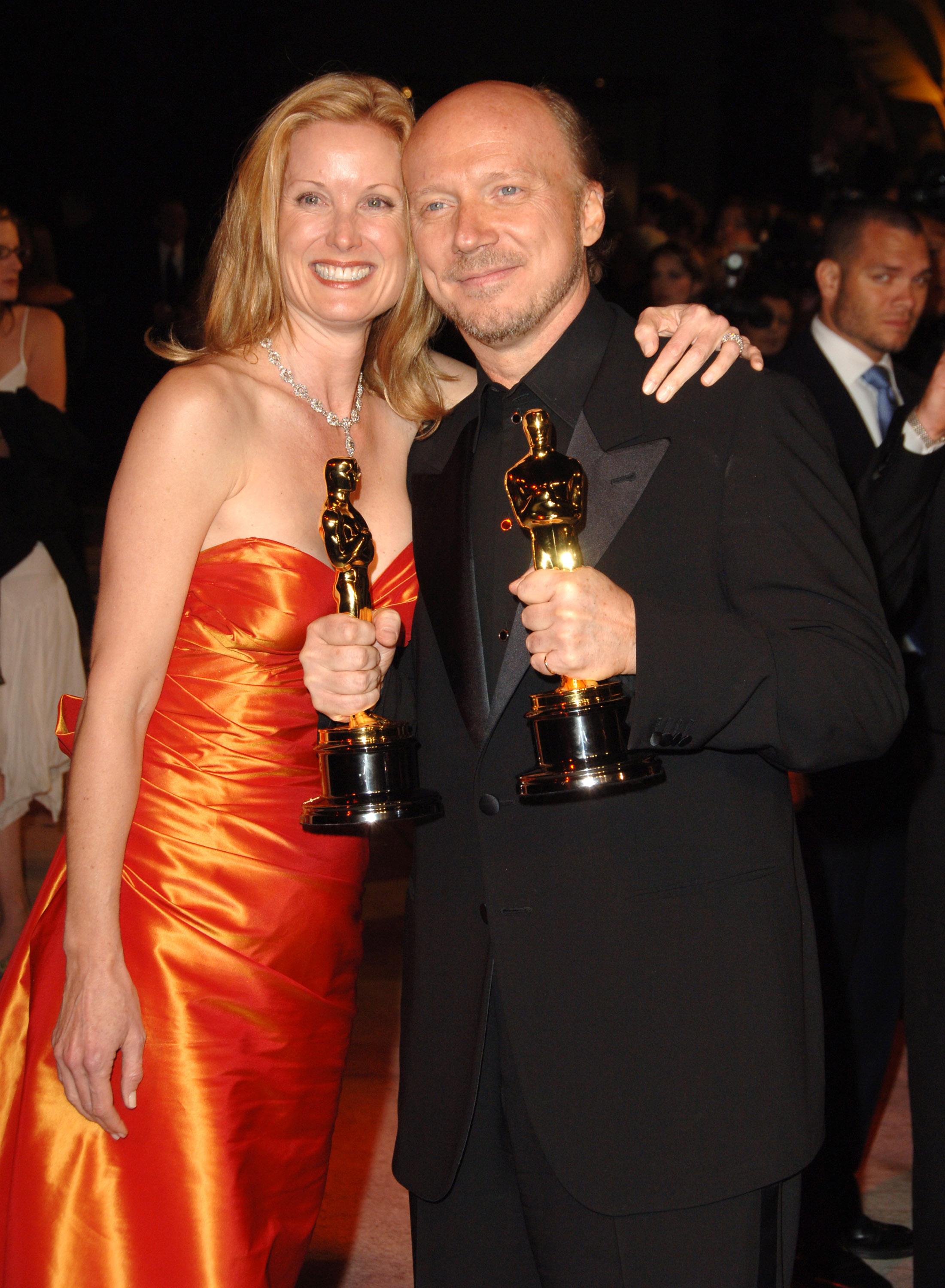 Paul Haggis holding his winnings for Best Picture and Best Original Screenplay for "Crash" and Deborah Rennard at the Vanity Fair Oscar Party on March 5, 2006 | Source: Getty Images