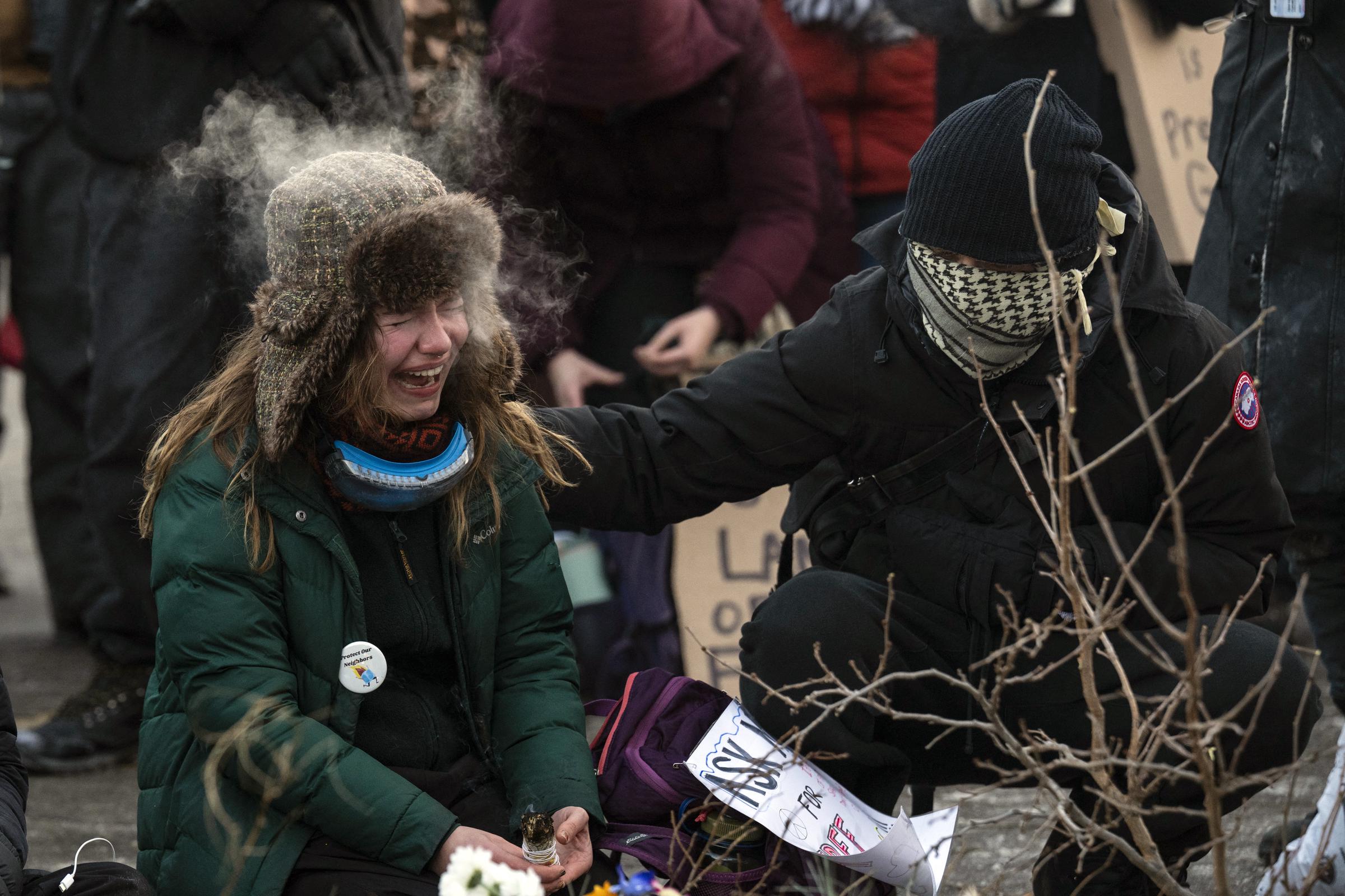 A woman cries at a makeshift memorial in the area where Alex Pretti was shot by federal immigration agents on January 24, 2026, in Minneapolis, Minnesota | Source: Getty Images