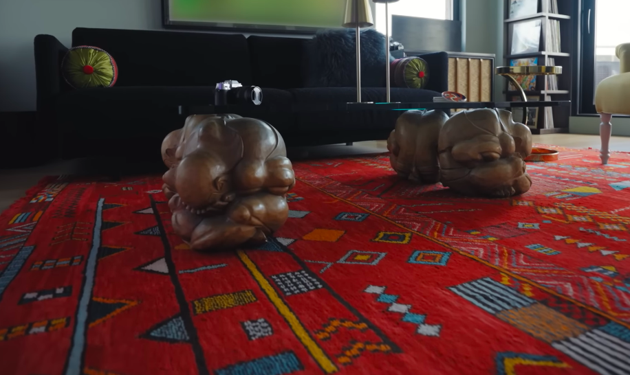 Some of the home's strangest carved objects are these yogi table leg sculptures. They are exactly the kind of unexpected pairings that gives these immaculate rooms their personality. | Source: YouTube/Architectural Digest