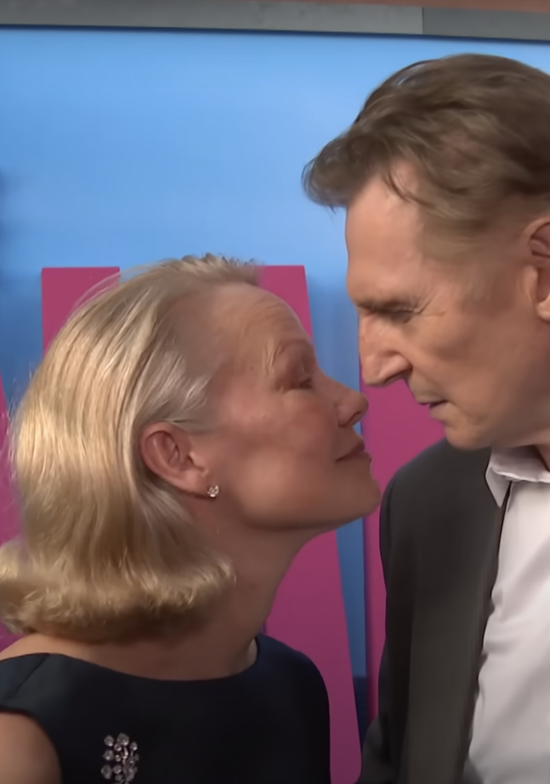 Pamela Anderson and Liam Neeson gazing into each other's eyes on the red carpet, dated July 2025 | Source: YouTube/EntertainmentTonight