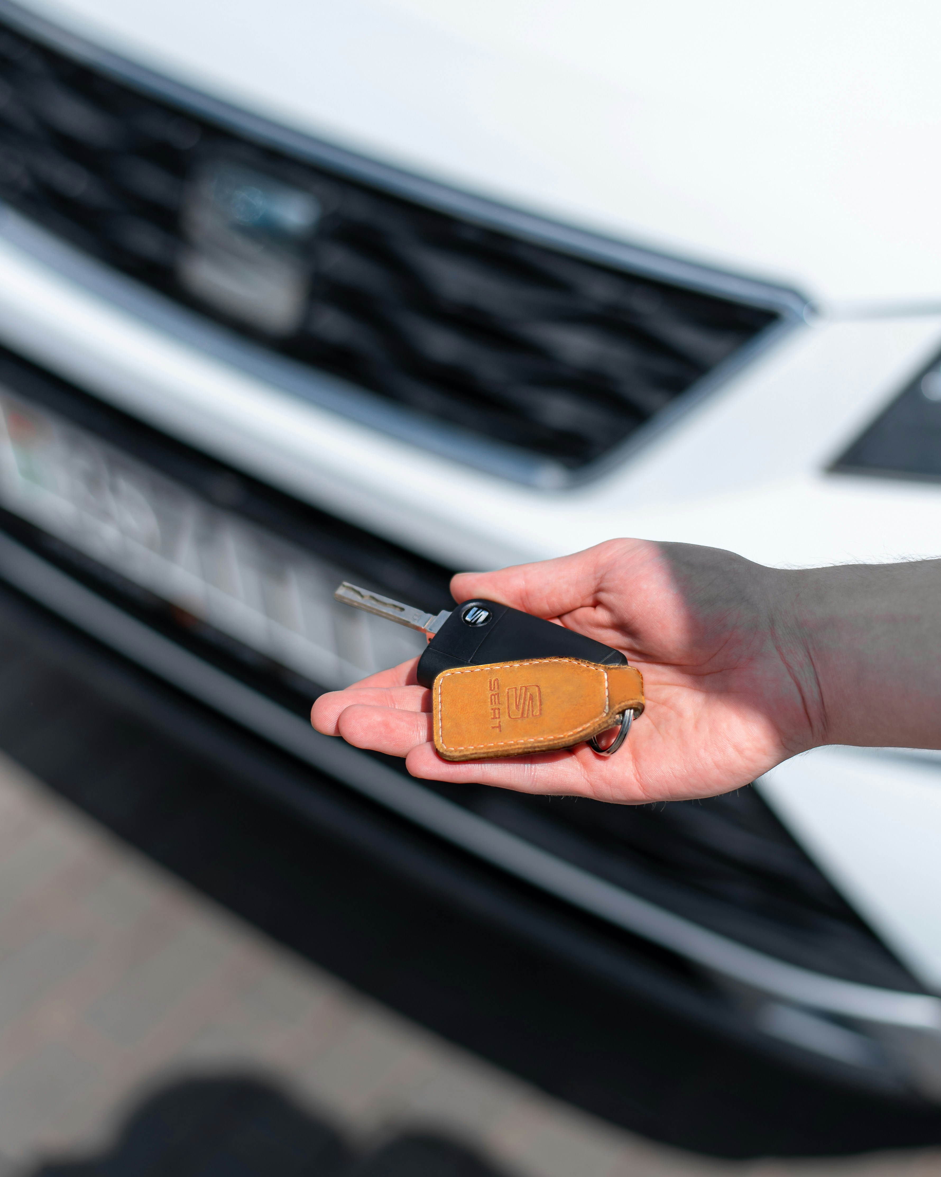 A person holding a car key in their hand | Source: Unsplash