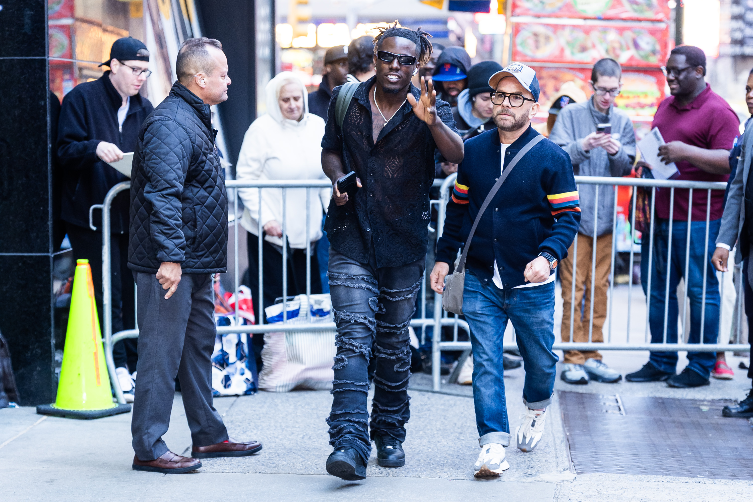 Jamal Roberts walks through Midtown, New York City, greeting fans and flashing a peace sign on May 20, 2025 | Source: Getty Images