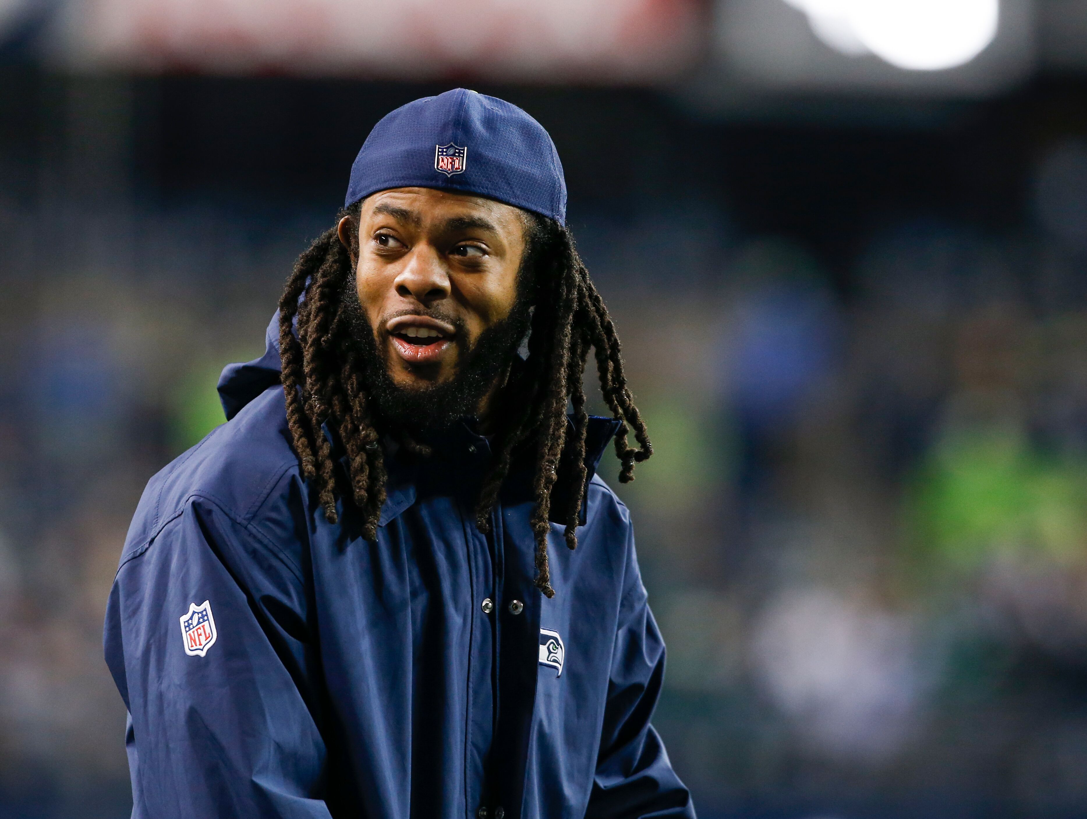 Cornerback Richard Sherman smiling from the sidelines before the Seattle Seahawks game against the Philadelphia Eagles at CenturyLink Field in Seattle, Washington | Photo: Getty Images