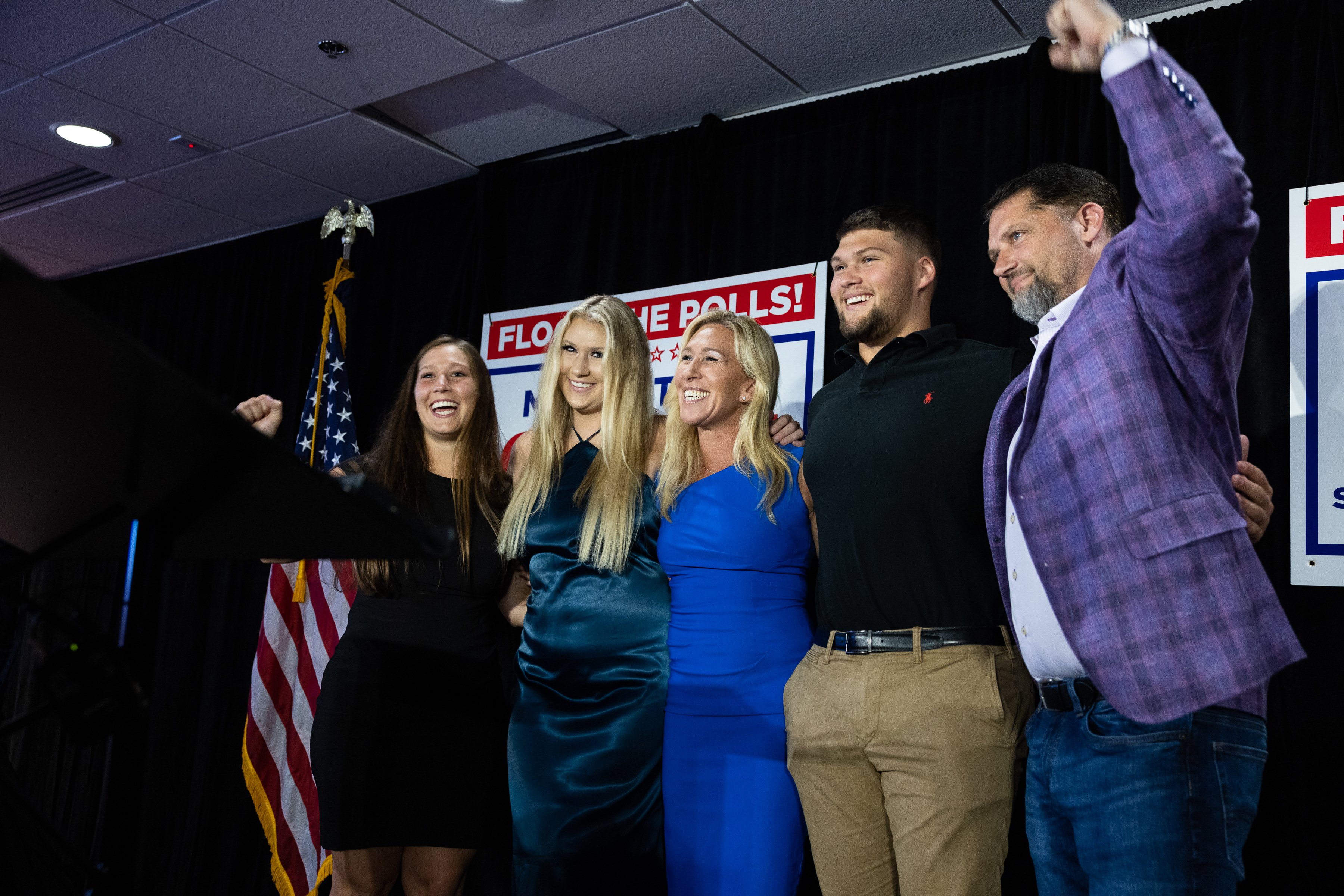 Georgia Representative Marjorie Taylor Greene is surrounded by her three children and husband Perry Greene (raising his fist) at a primary election watch party on May 24, 2022, in Rome, Georgia. | Source: Getty Images