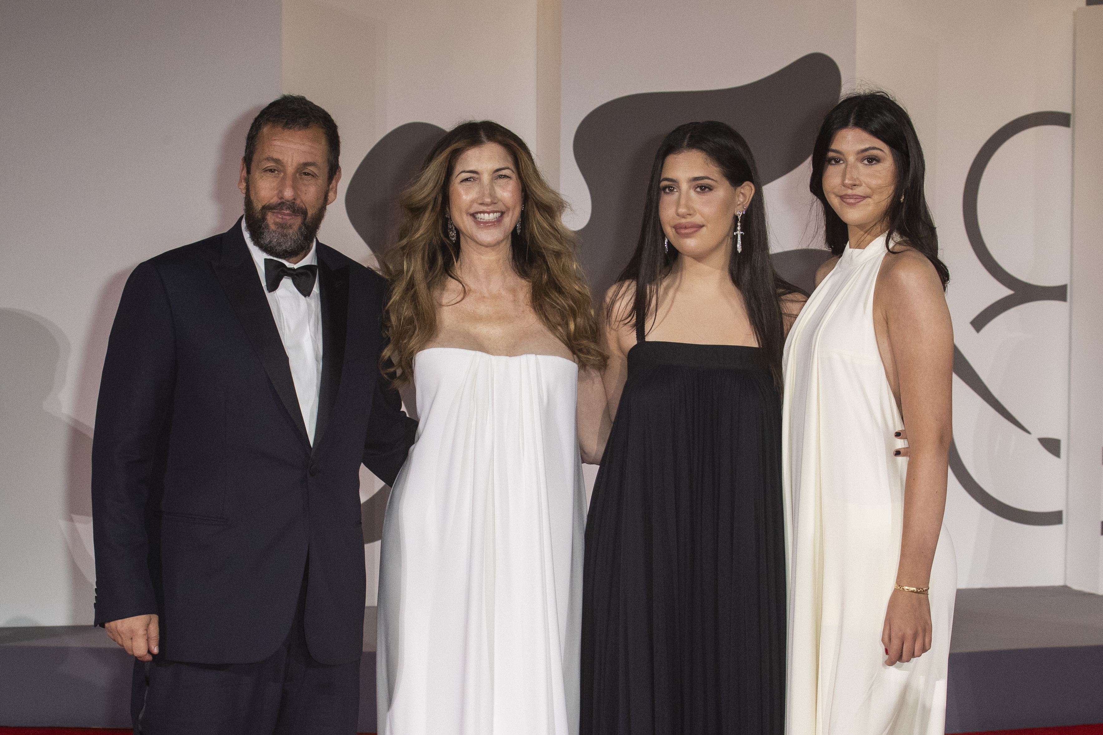 The Sandlers’ appearance at the ‘Jay Kelly’ red carpet in Venice beautifully contrasts with moments from years past, showing how Sunny and Sadie have grown into stunning young women who now mirror both Adam and Jackie Sandler in grace and charm.