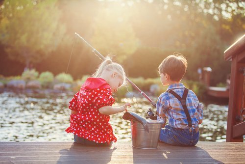 A girl and a boy fishing. | Source: Shutterstock.