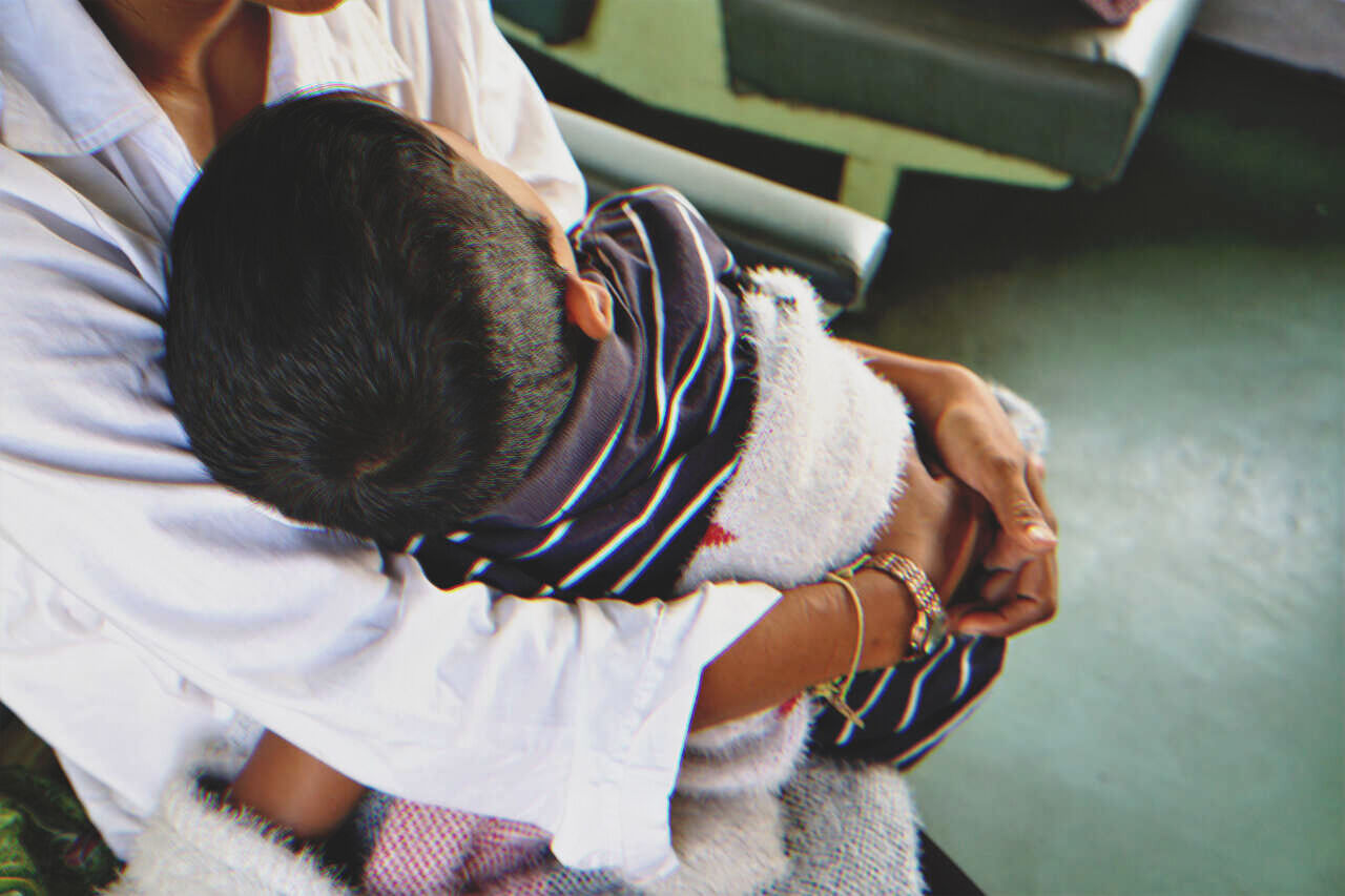Woman holding a little boy | Source: Shutterstock