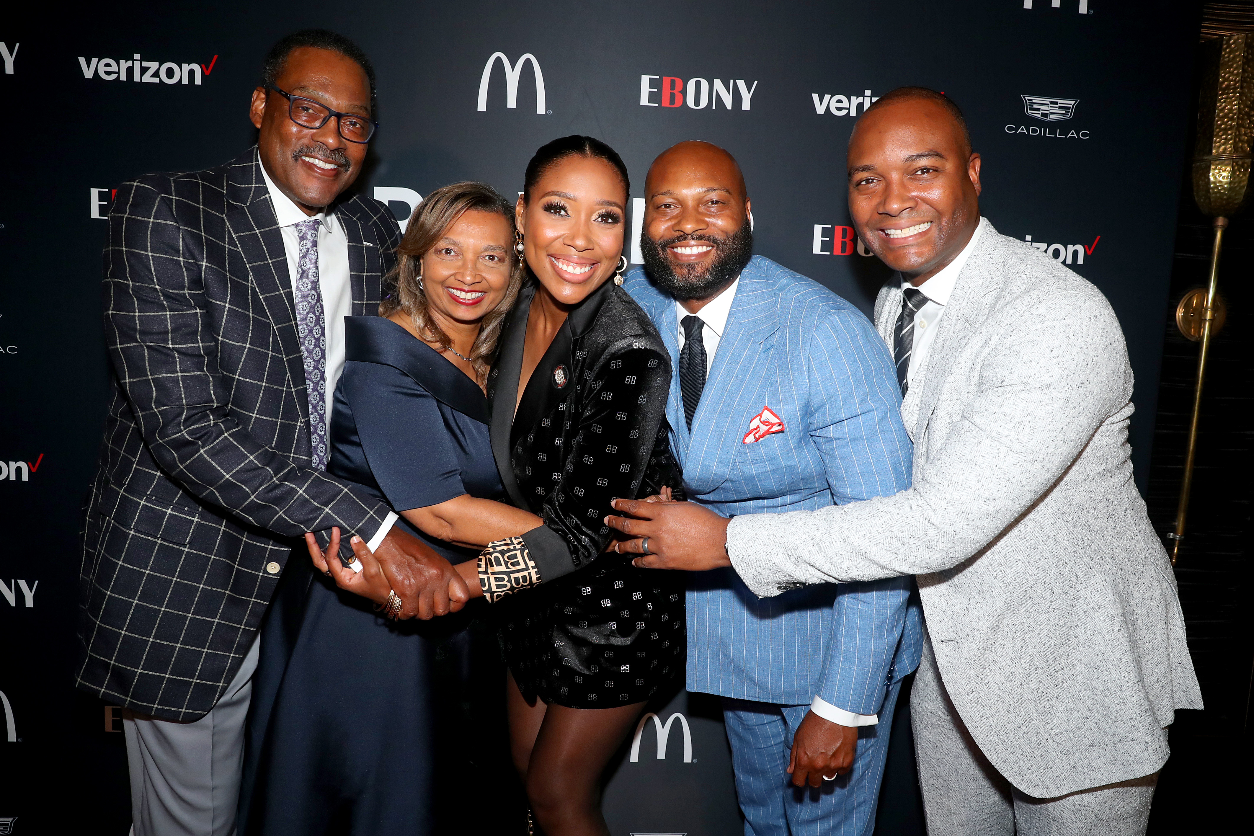 Junior Bridgeman and Doris Griffith with their kids, Eden Bridgeman, Justin Bridgeman, and Ryan Bridgeman, posing for photos at the Power 100 Kick Off. | Source: Getty Images