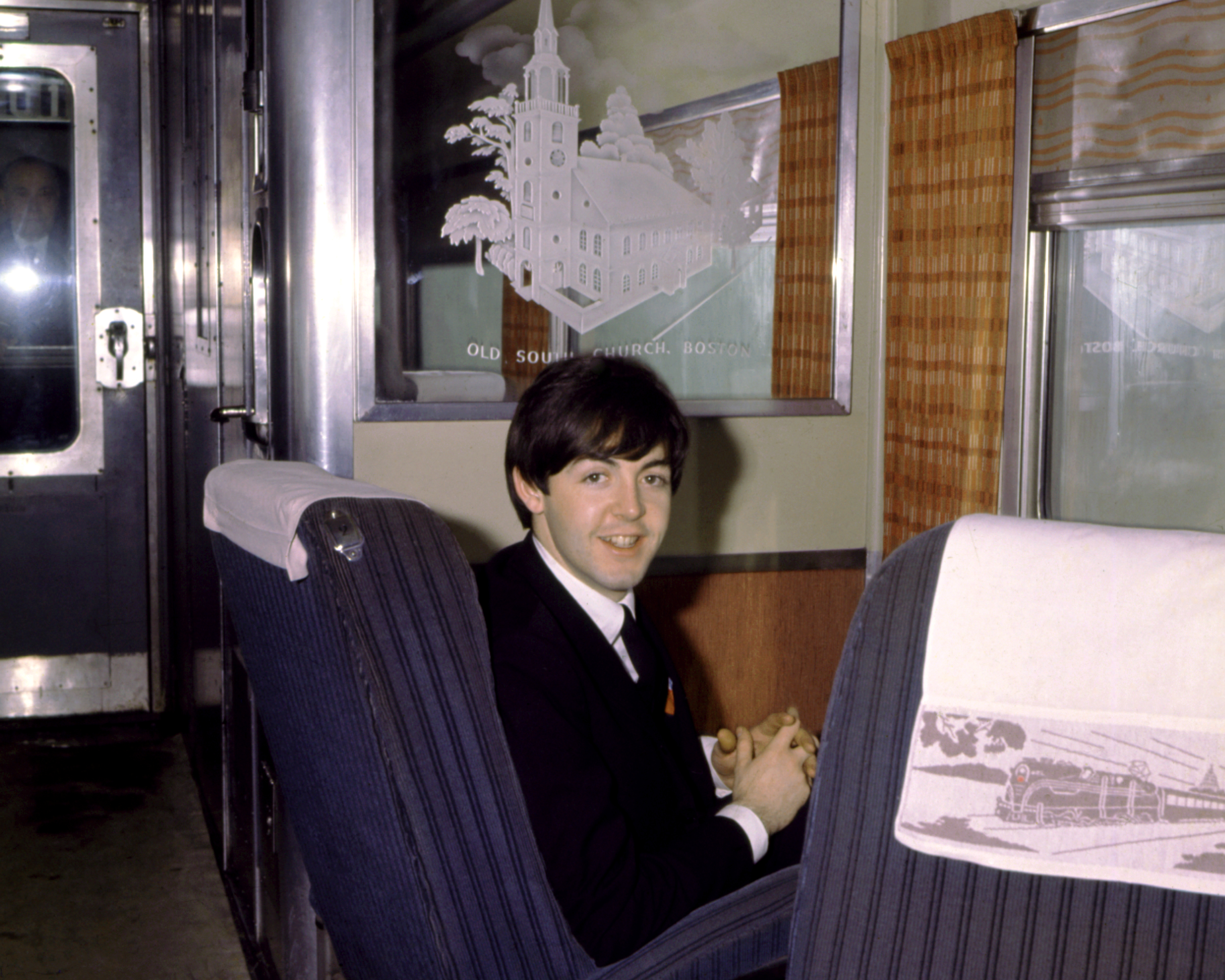 Paul McCartney of the rock band "The Beatles" poses for a portrait sitting on a train in Boston, Massachusetts in 1964. | Source: Getty Images
