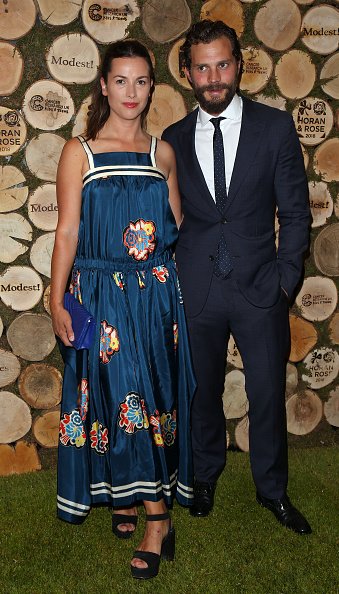 Amelia Warner and Jamie Dornan at The Grove on June 23, 2018 in Watford, England. | Photo: Getty Images