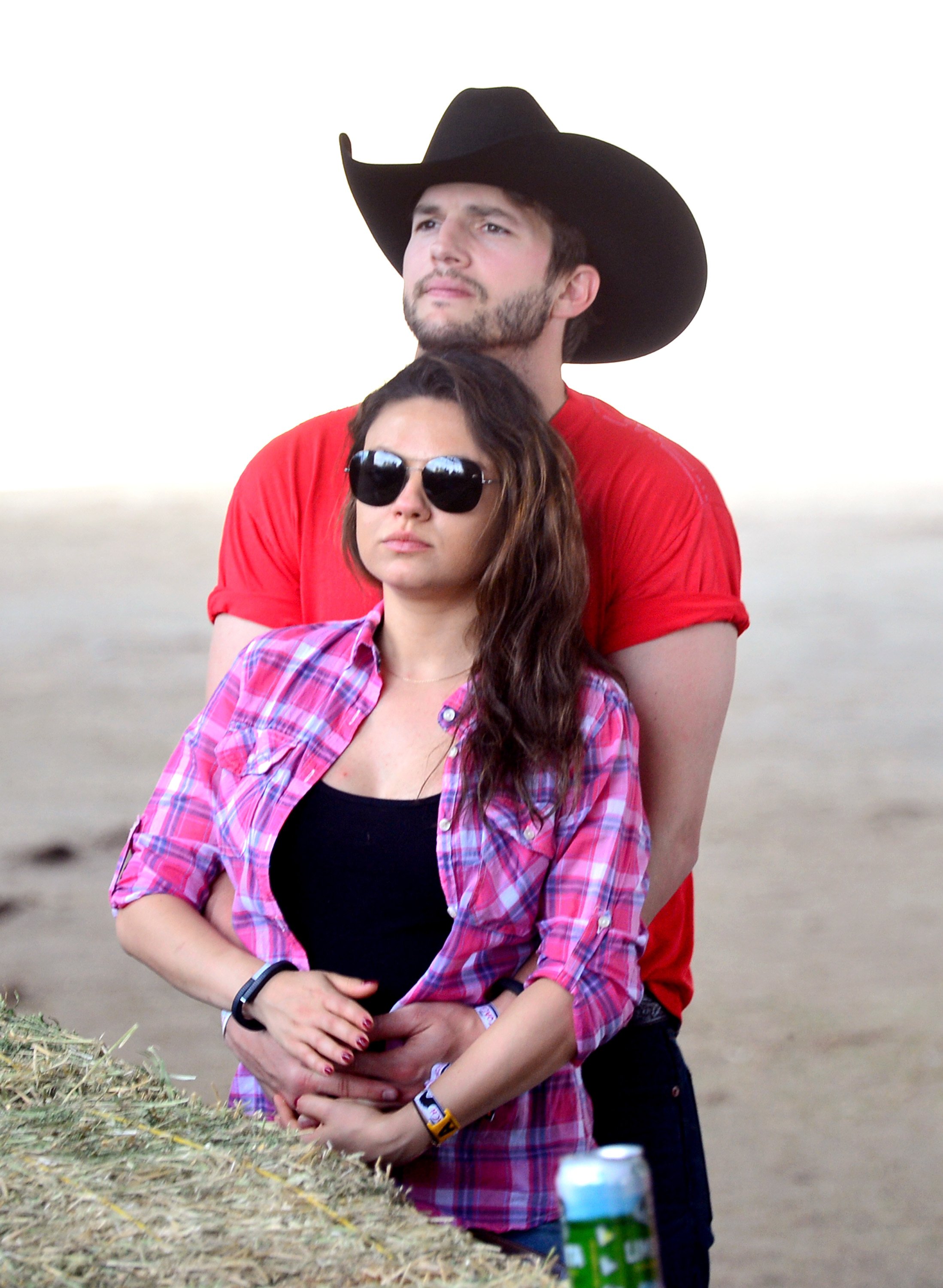 Actors Ashton Kutcher (L) and Mila Kunis attend day 1 of 2014 Stagecoach: California's Country Music Festival at the Empire Polo Club on April 25, 2014 | Source: Getty  Images 