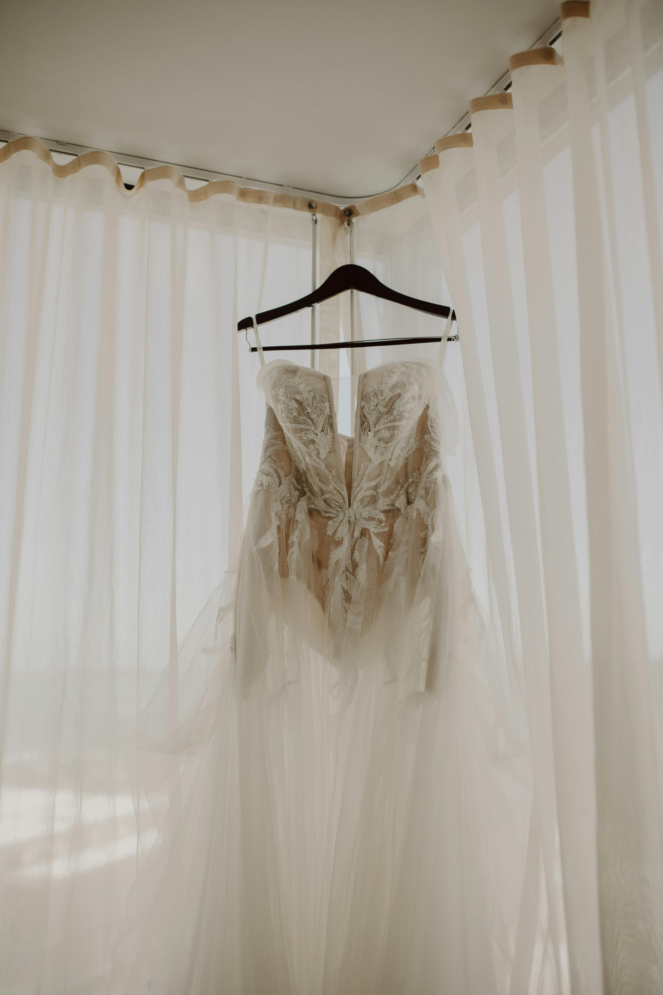 For illustration purposes only. Wedding gown on a hanger | Source: Pexels