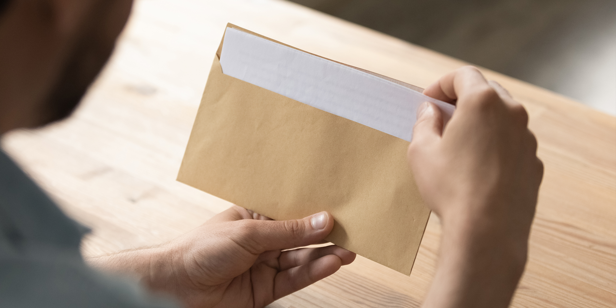 Someone opening a letter | Source: Shutterstock